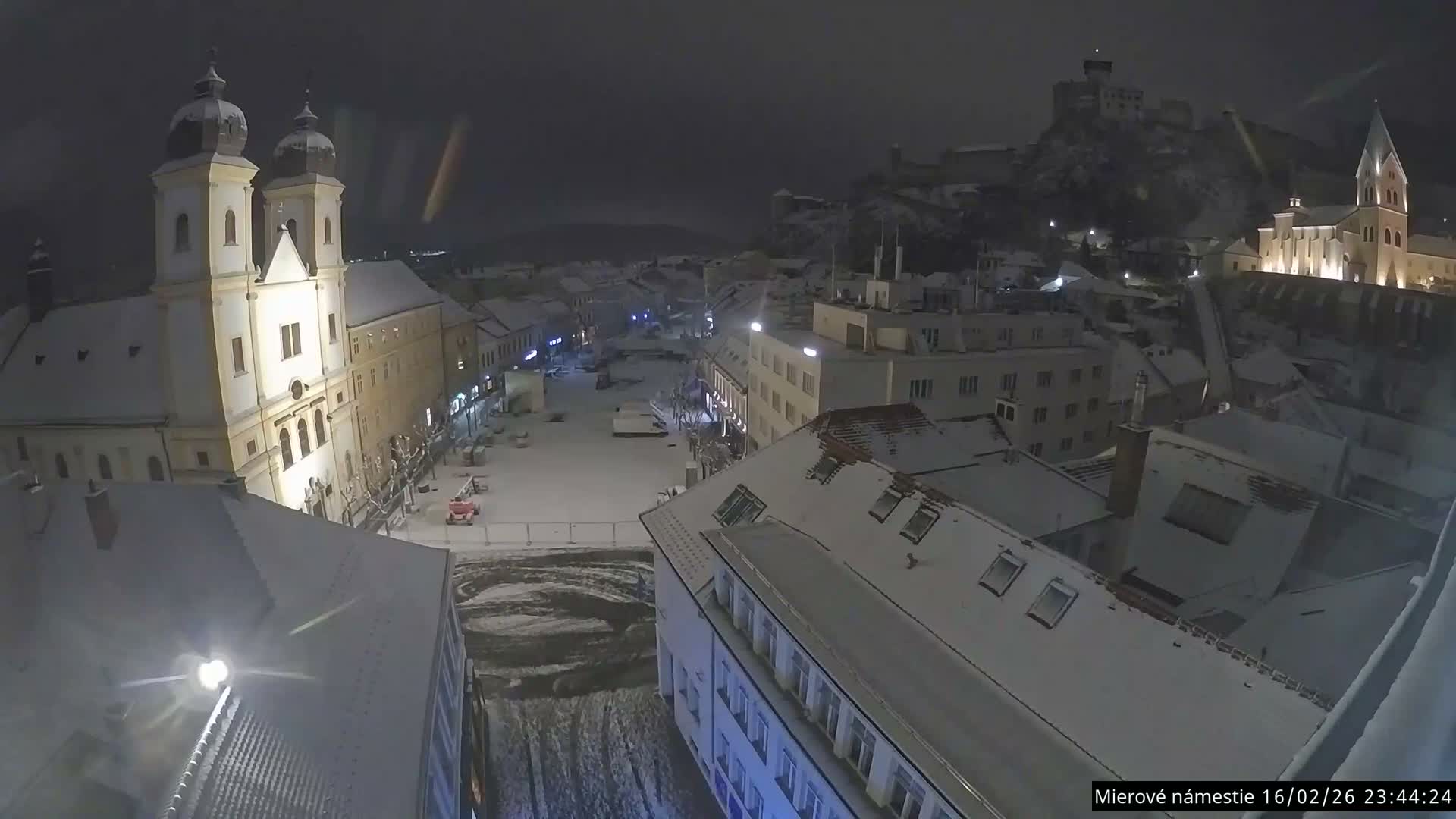 Trenčín, Piaristický kostol sv. Františka Xaverského Church & Trenciansky Hrad (Ttencin Castle) at Mierové námestie Square East View Live Cam - Trencin, Okres Trencin, Slovakia 