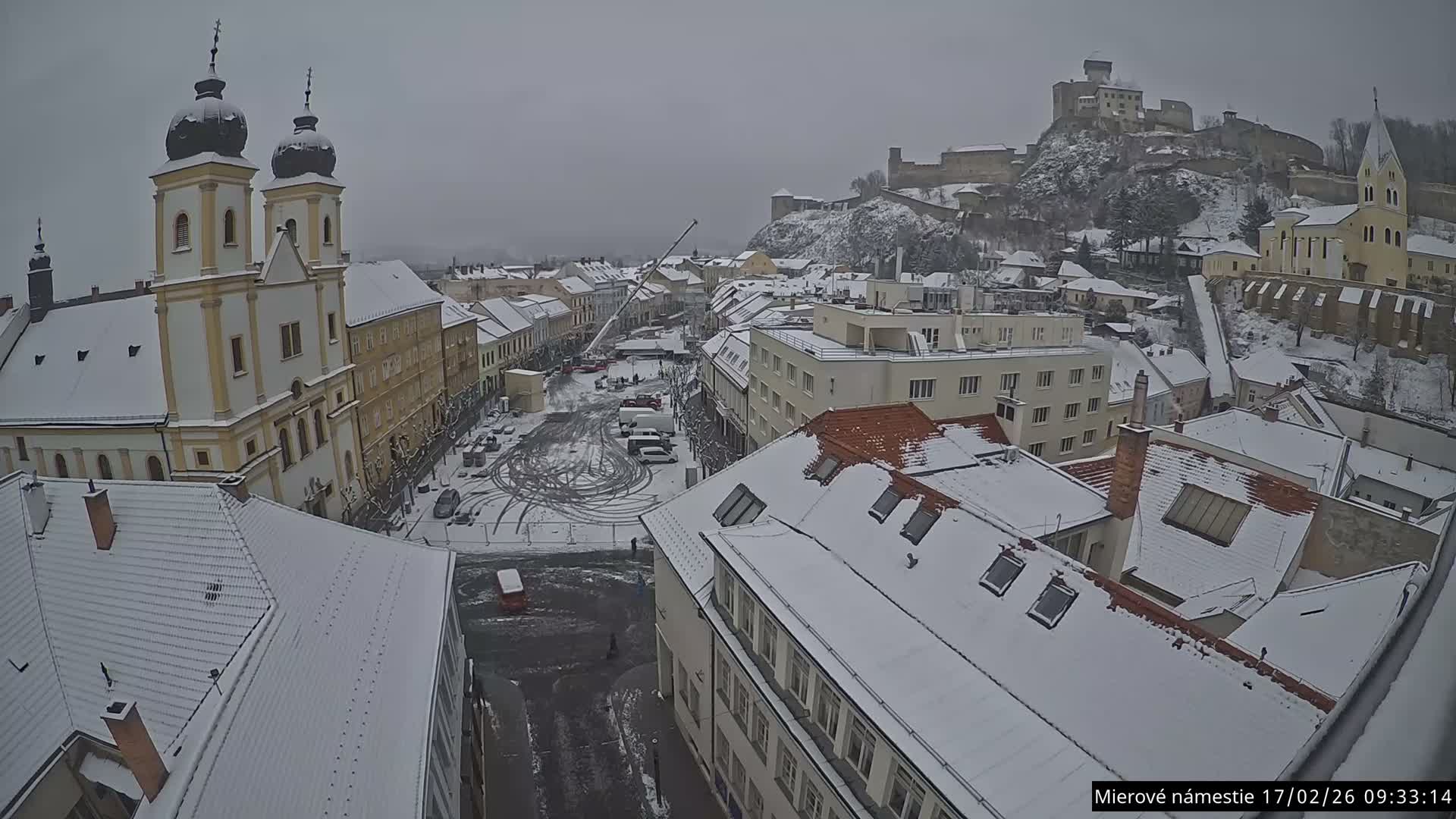 Trenčín, Piaristický kostol sv. Františka Xaverského Church & Trenciansky Hrad (Ttencin Castle) at Mierové námestie Square East View Live Cam - Trencin, Okres Trencin, Slovakia 