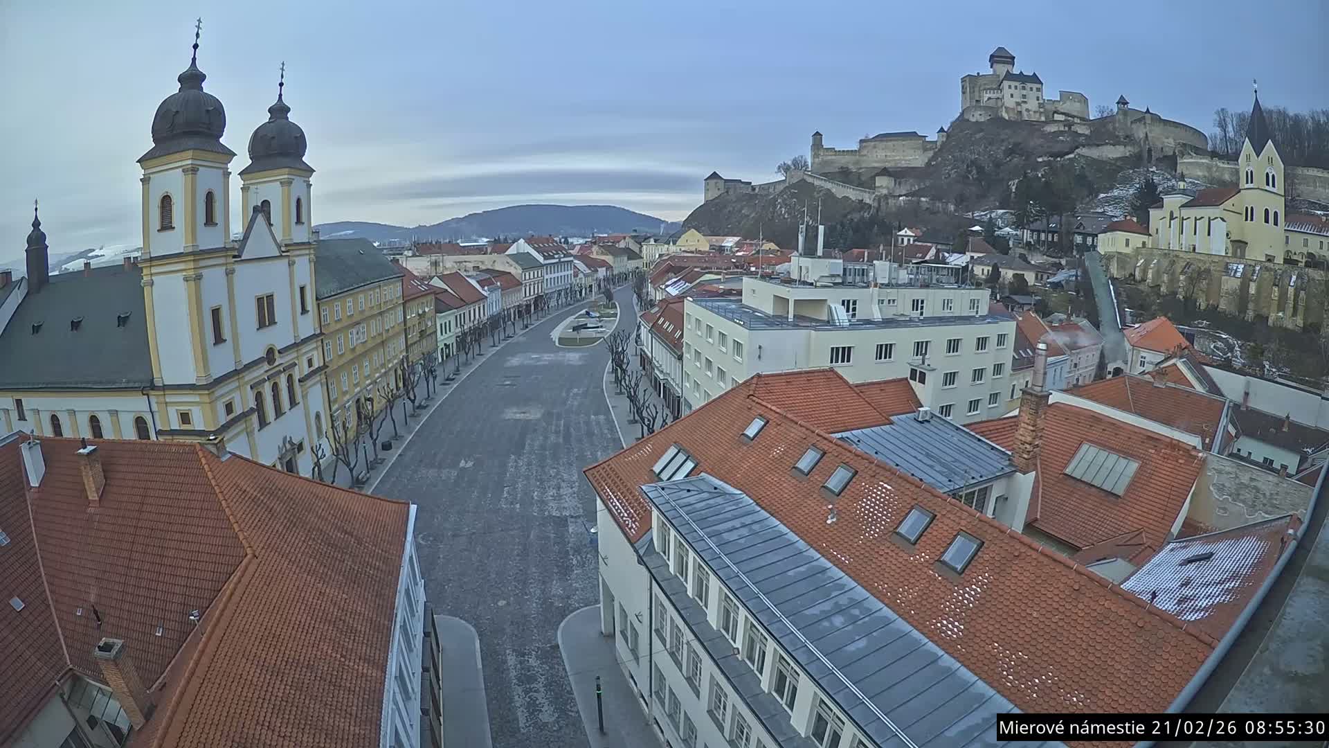 Trenčín, Piaristický kostol sv. Františka Xaverského Church & Trenciansky Hrad (Ttencin Castle) at Mierové námestie Square East View Live Cam - Trencin, Okres Trencin, Slovakia 