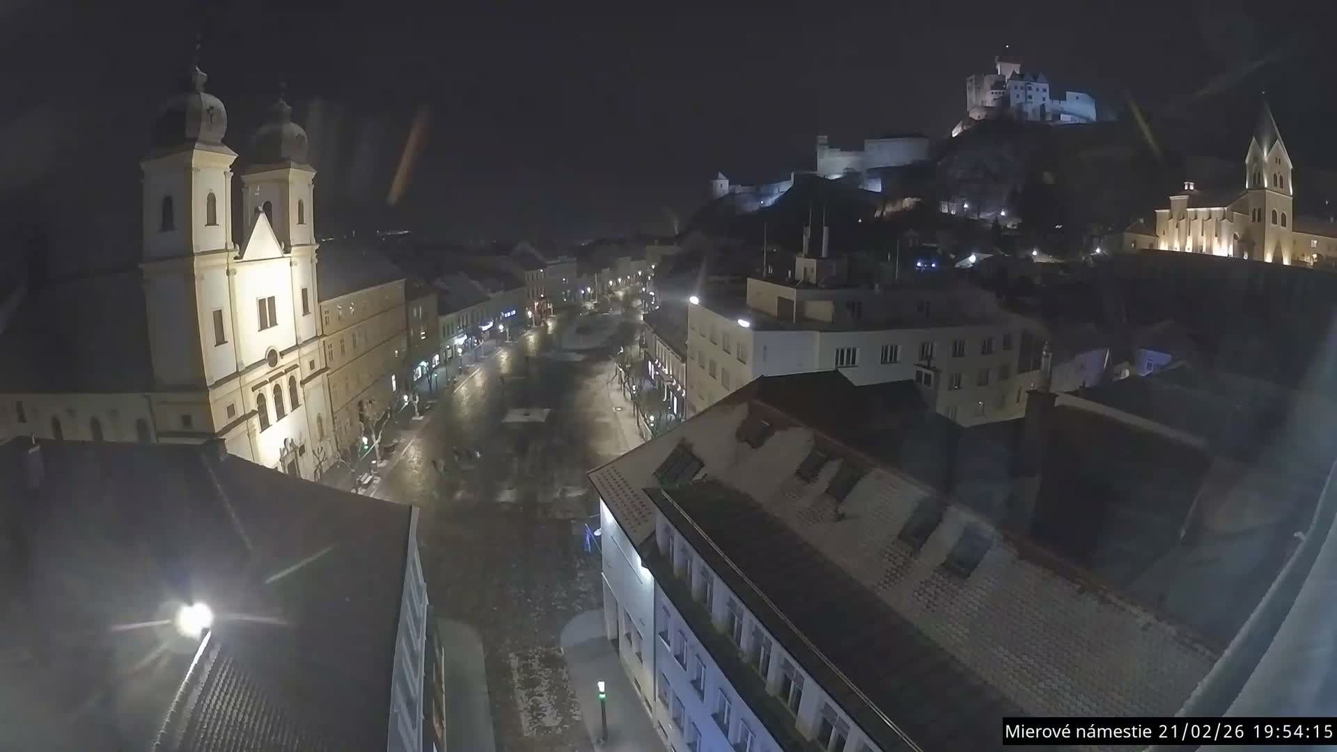 Trenčín, Piaristický kostol sv. Františka Xaverského Church & Trenciansky Hrad (Ttencin Castle) at Mierové námestie Square East View Live Cam - Trencin, Okres Trencin, Slovakia 