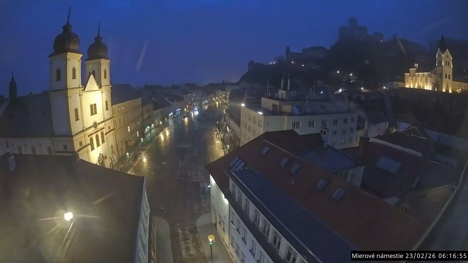 Trenčín, Piaristický kostol sv. Františka Xaverského Church & Trenciansky Hrad (Ttencin Castle) at Mierové námestie Square East View Live Cam - Trencin, Okres Trencin, Slovakia 