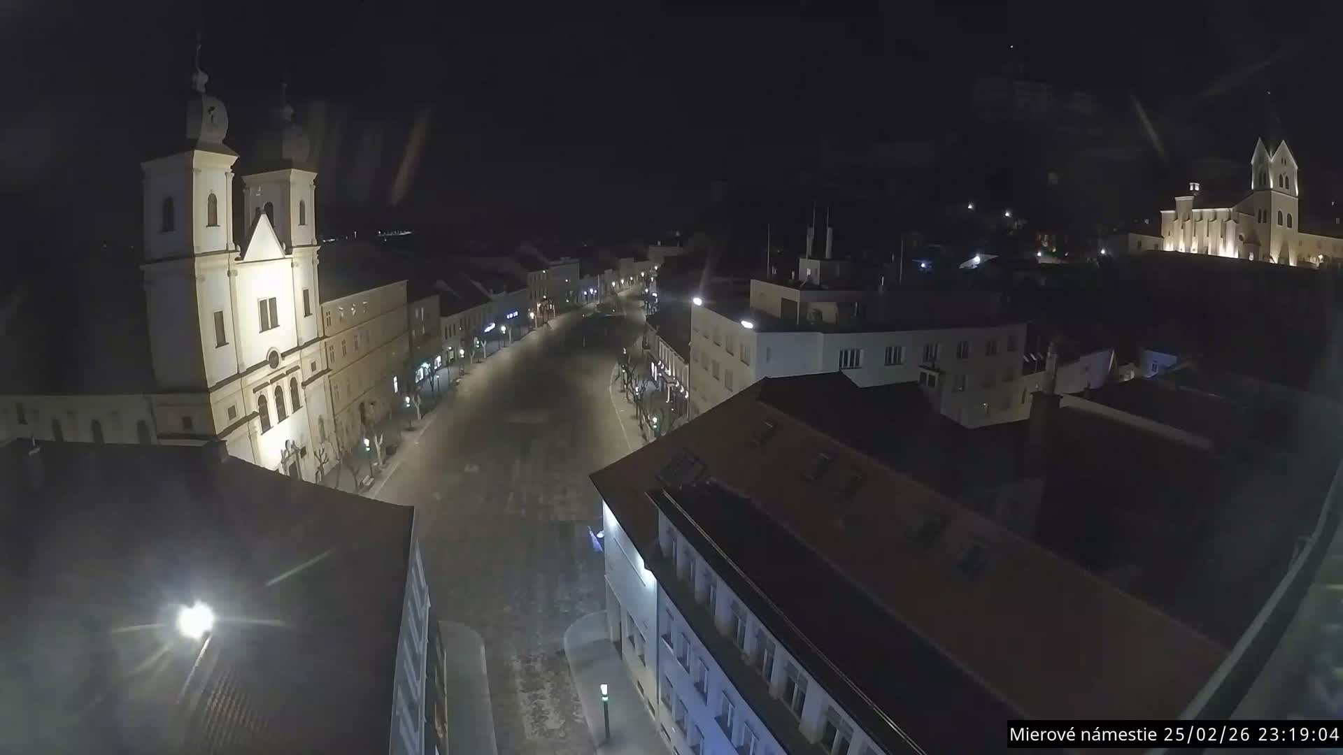 Trenčín, Piaristický kostol sv. Františka Xaverského Church & Trenciansky Hrad (Ttencin Castle) at Mierové námestie Square East View Live Cam - Trencin, Okres Trencin, Slovakia 