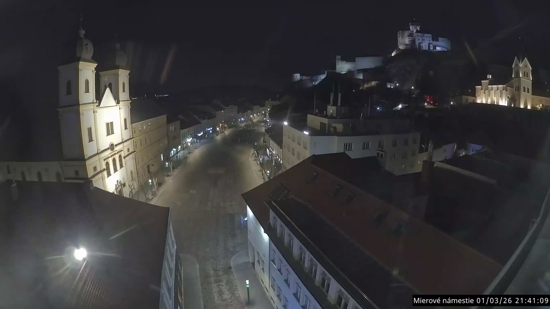 Trenčín, Piaristický kostol sv. Františka Xaverského Church & Trenciansky Hrad (Ttencin Castle) at Mierové námestie Square East View Live Cam - Trencin, Okres Trencin, Slovakia 