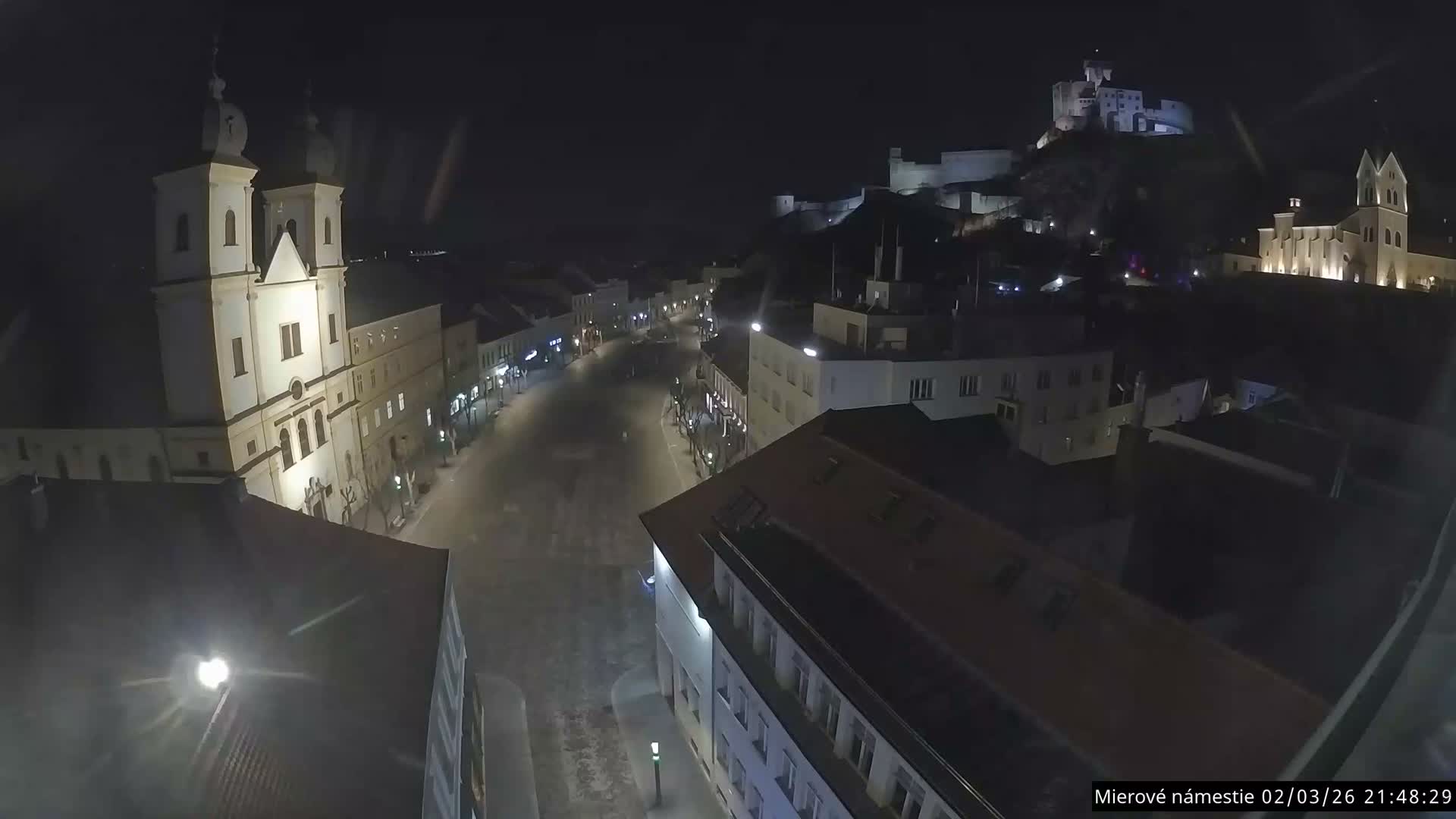 Trenčín, Piaristický kostol sv. Františka Xaverského Church & Trenciansky Hrad (Ttencin Castle) at Mierové námestie Square East View Live Cam - Trencin, Okres Trencin, Slovakia 