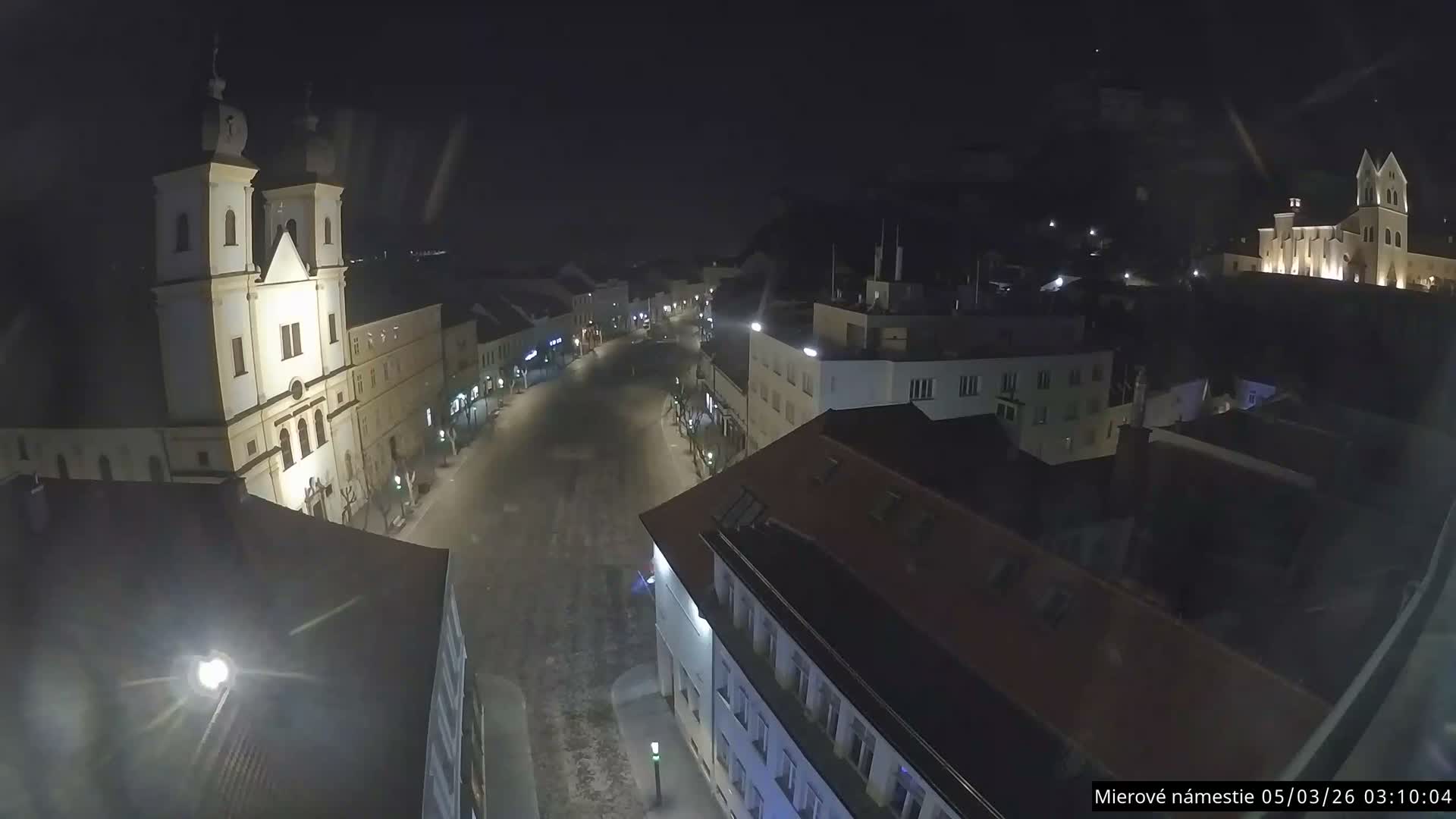 Trenčín, Piaristický kostol sv. Františka Xaverského Church & Trenciansky Hrad (Ttencin Castle) at Mierové námestie Square East View Live Cam - Trencin, Okres Trencin, Slovakia 