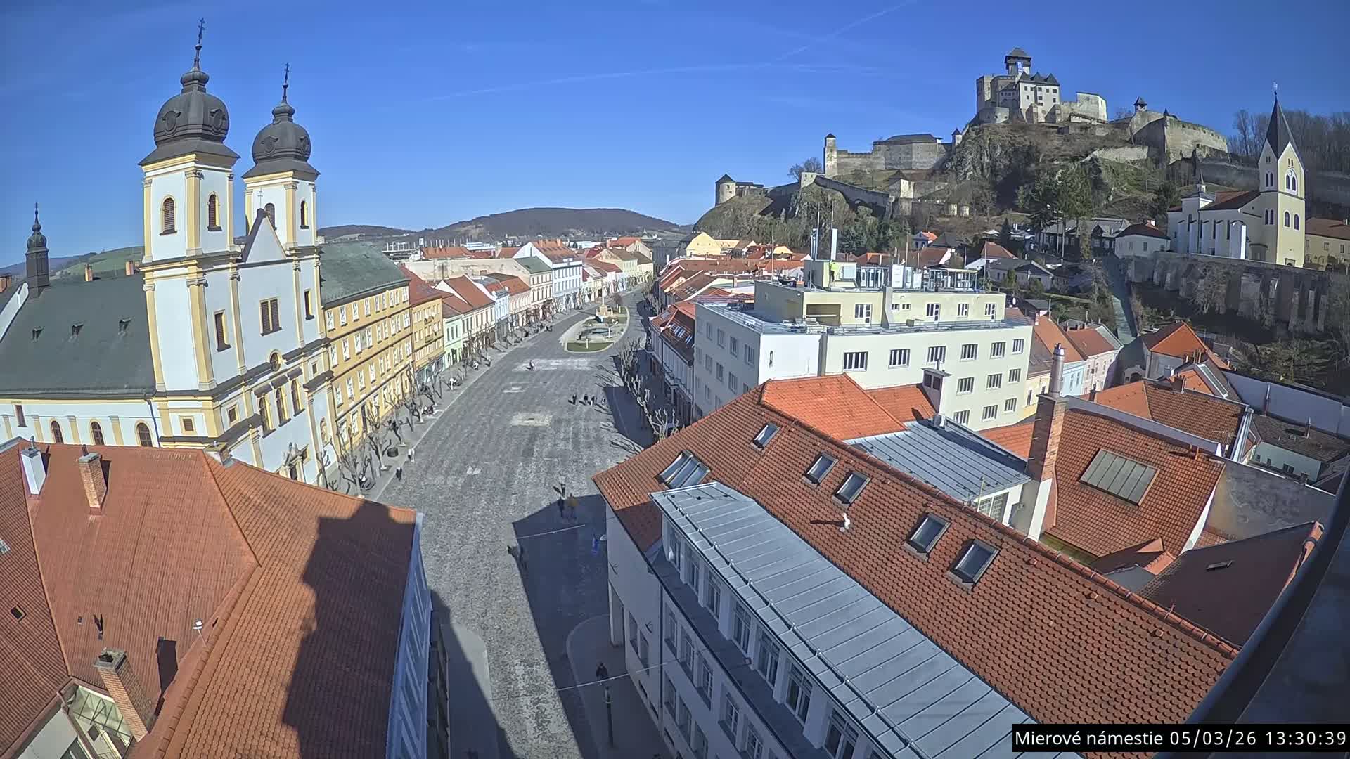 Trenčín, Piaristický kostol sv. Františka Xaverského Church & Trenciansky Hrad (Ttencin Castle) at Mierové námestie Square East View Live Cam - Trencin, Okres Trencin, Slovakia 