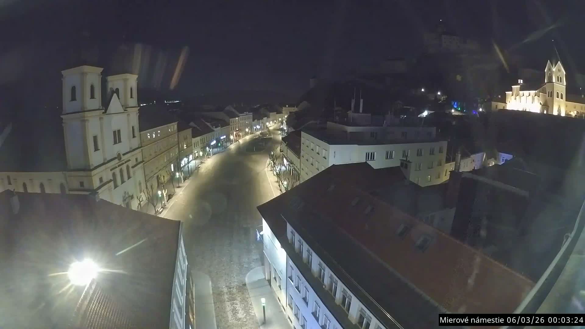 Trenčín, Piaristický kostol sv. Františka Xaverského Church & Trenciansky Hrad (Ttencin Castle) at Mierové námestie Square East View Live Cam - Trencin, Okres Trencin, Slovakia 
