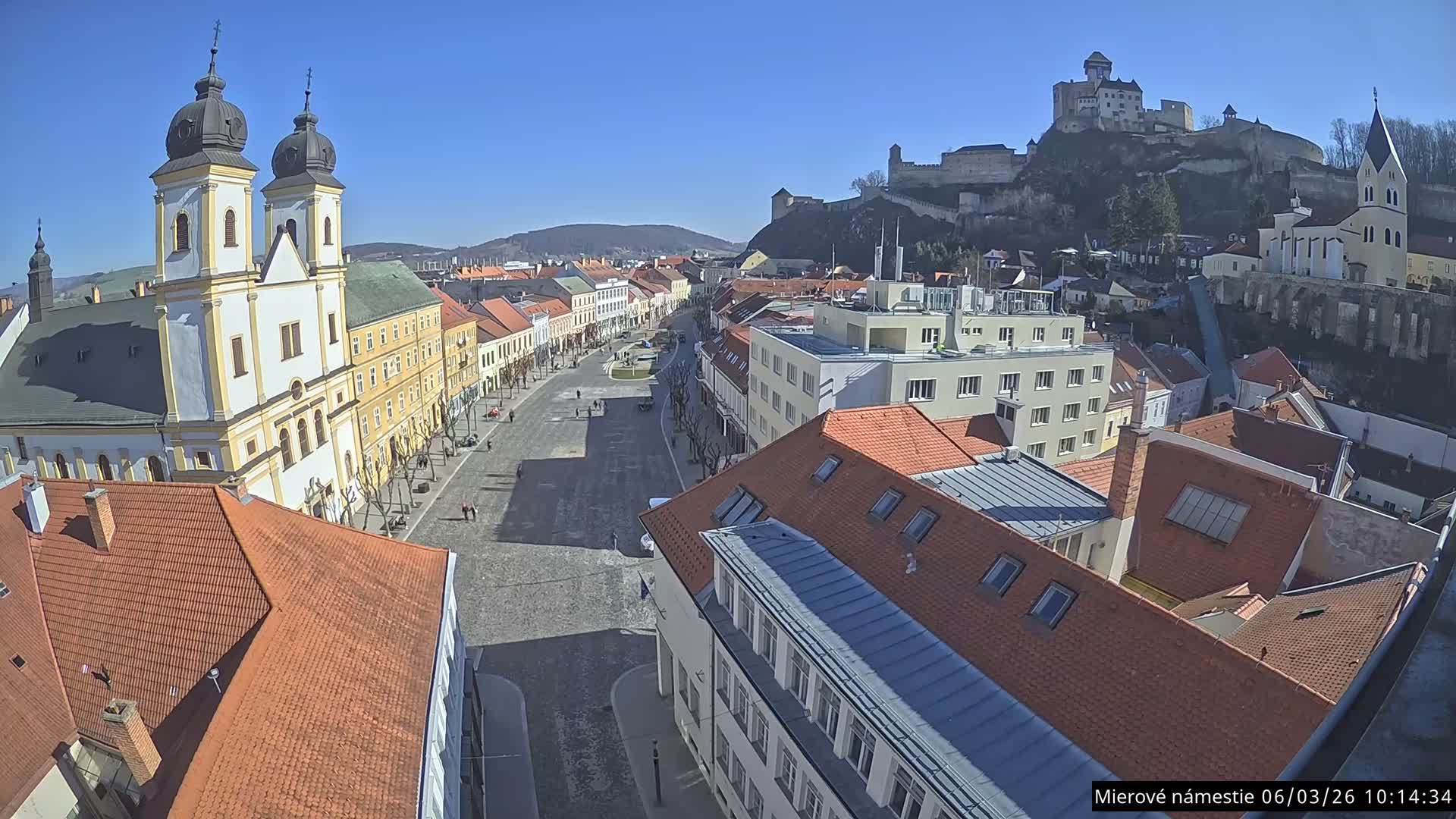 Trenčín, Piaristický kostol sv. Františka Xaverského Church & Trenciansky Hrad (Ttencin Castle) at Mierové námestie Square East View Live Cam - Trencin, Okres Trencin, Slovakia 