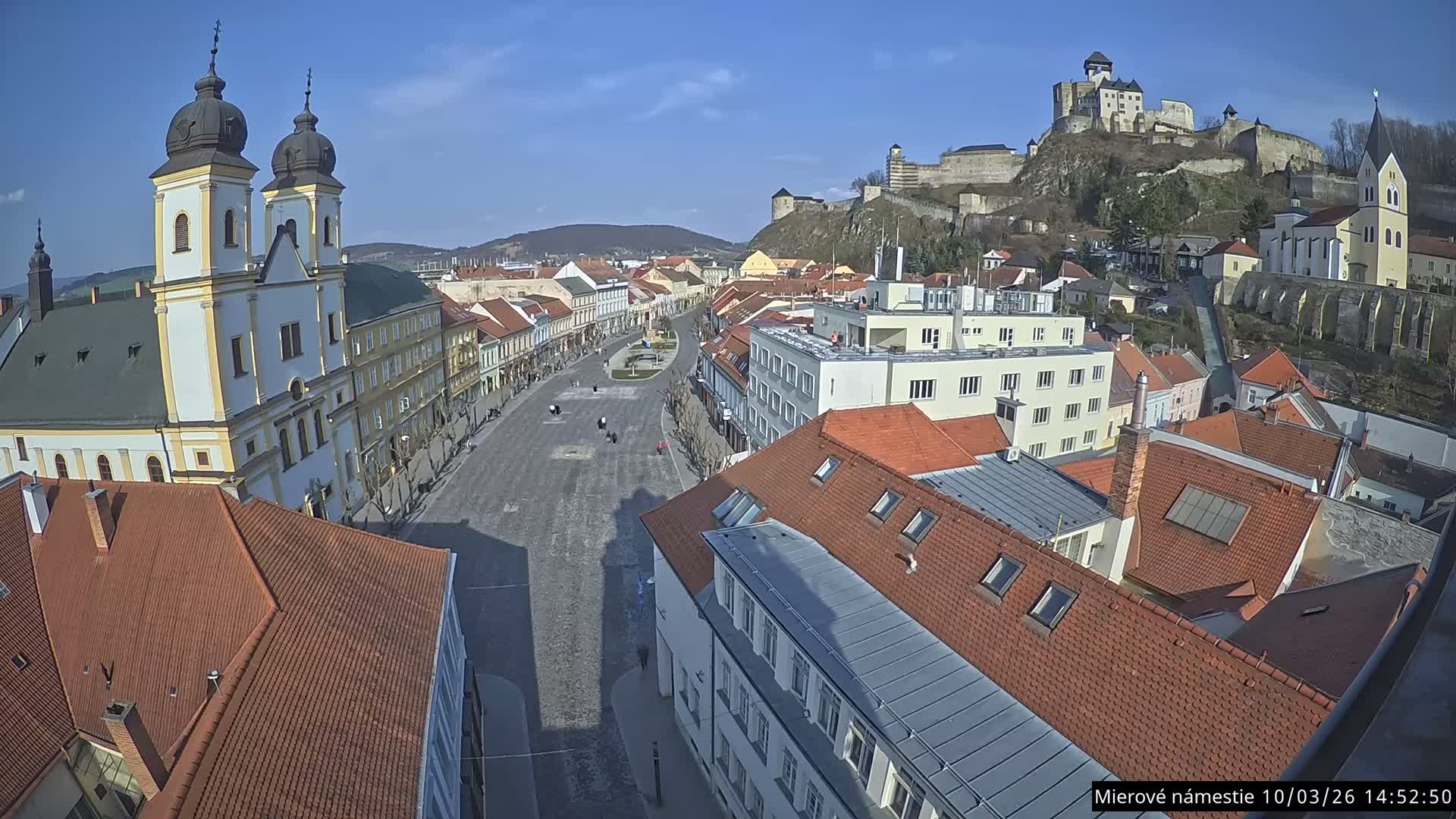 Trenčín, Piaristický kostol sv. Františka Xaverského Church & Trenciansky Hrad (Ttencin Castle) at Mierové námestie Square East View Live Cam - Trencin, Okres Trencin, Slovakia 