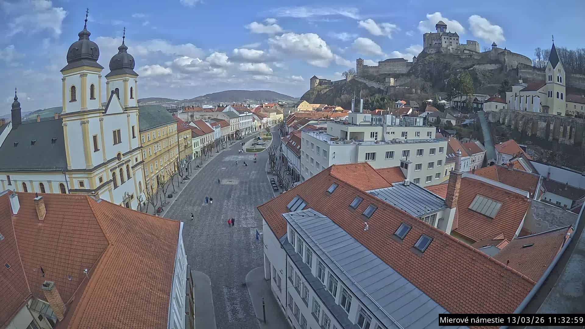 Trenčín, Piaristický kostol sv. Františka Xaverského Church & Trenciansky Hrad (Ttencin Castle) at Mierové námestie Square East View Live Cam - Trencin, Okres Trencin, Slovakia 