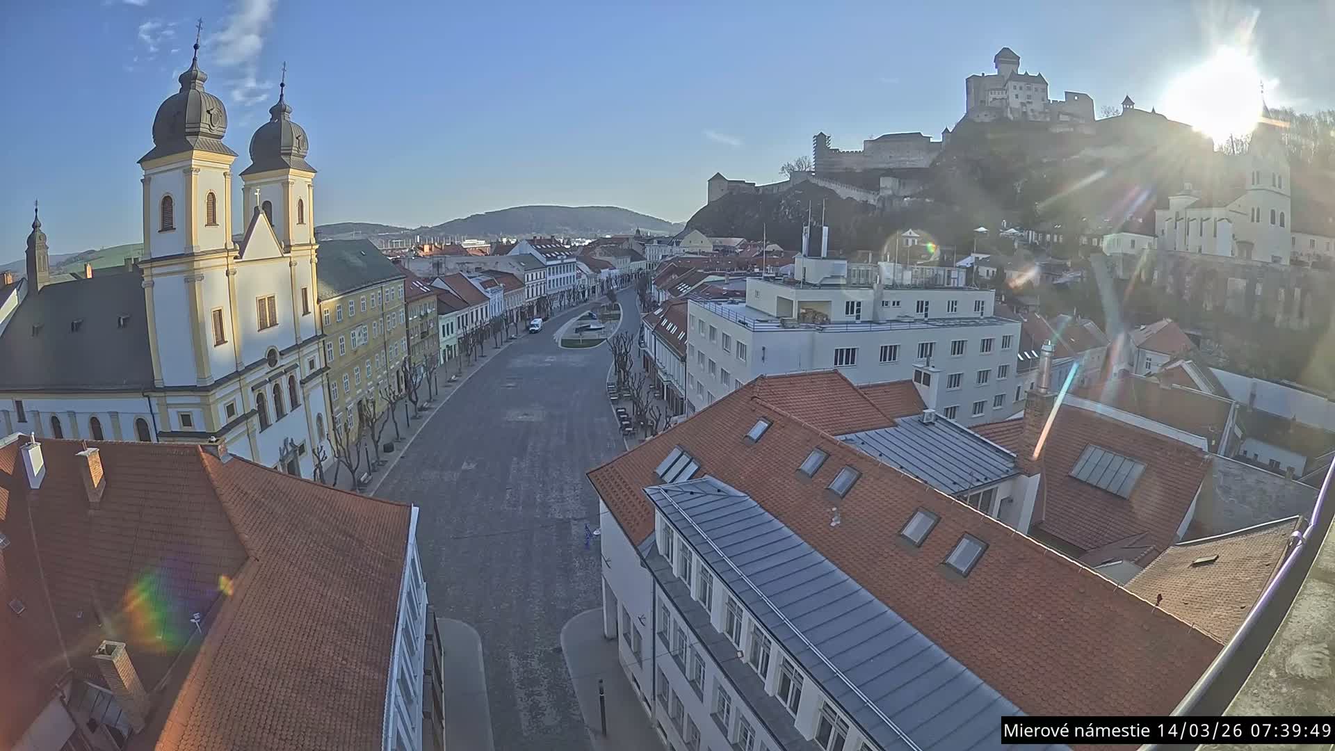 Trenčín, Piaristický kostol sv. Františka Xaverského Church & Trenciansky Hrad (Ttencin Castle) at Mierové námestie Square East View Live Cam - Trencin, Okres Trencin, Slovakia 