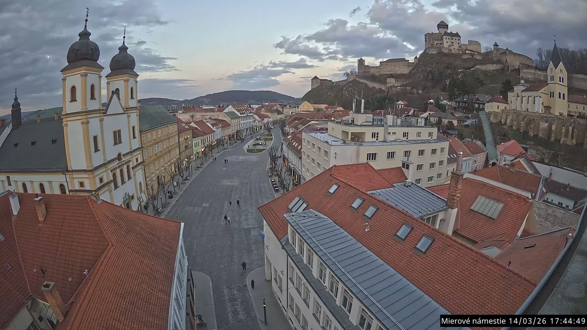 Trenčín, Piaristický kostol sv. Františka Xaverského Church & Trenciansky Hrad (Ttencin Castle) at Mierové námestie Square East View Live Cam - Trencin, Okres Trencin, Slovakia 