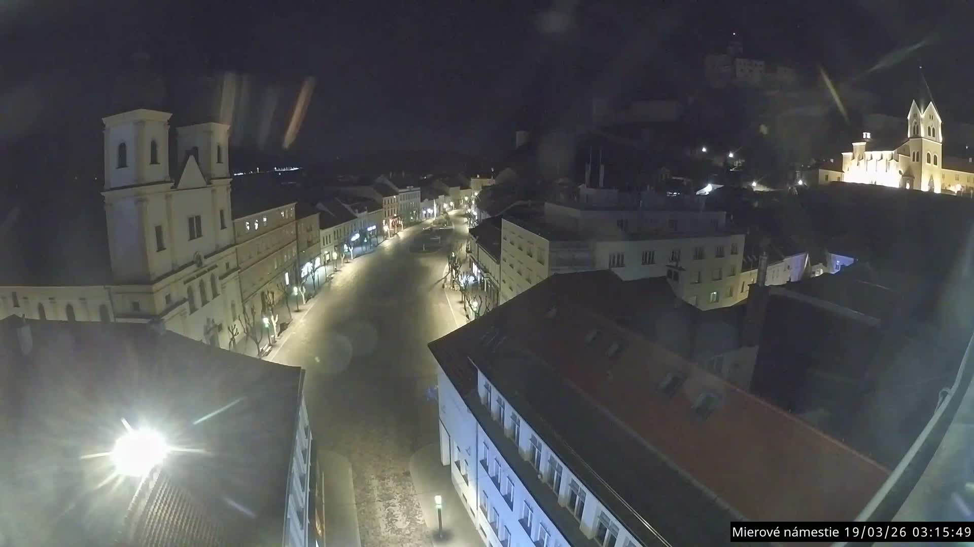 Trenčín, Piaristický kostol sv. Františka Xaverského Church & Trenciansky Hrad (Ttencin Castle) at Mierové námestie Square East View Live Cam - Trencin, Okres Trencin, Slovakia 