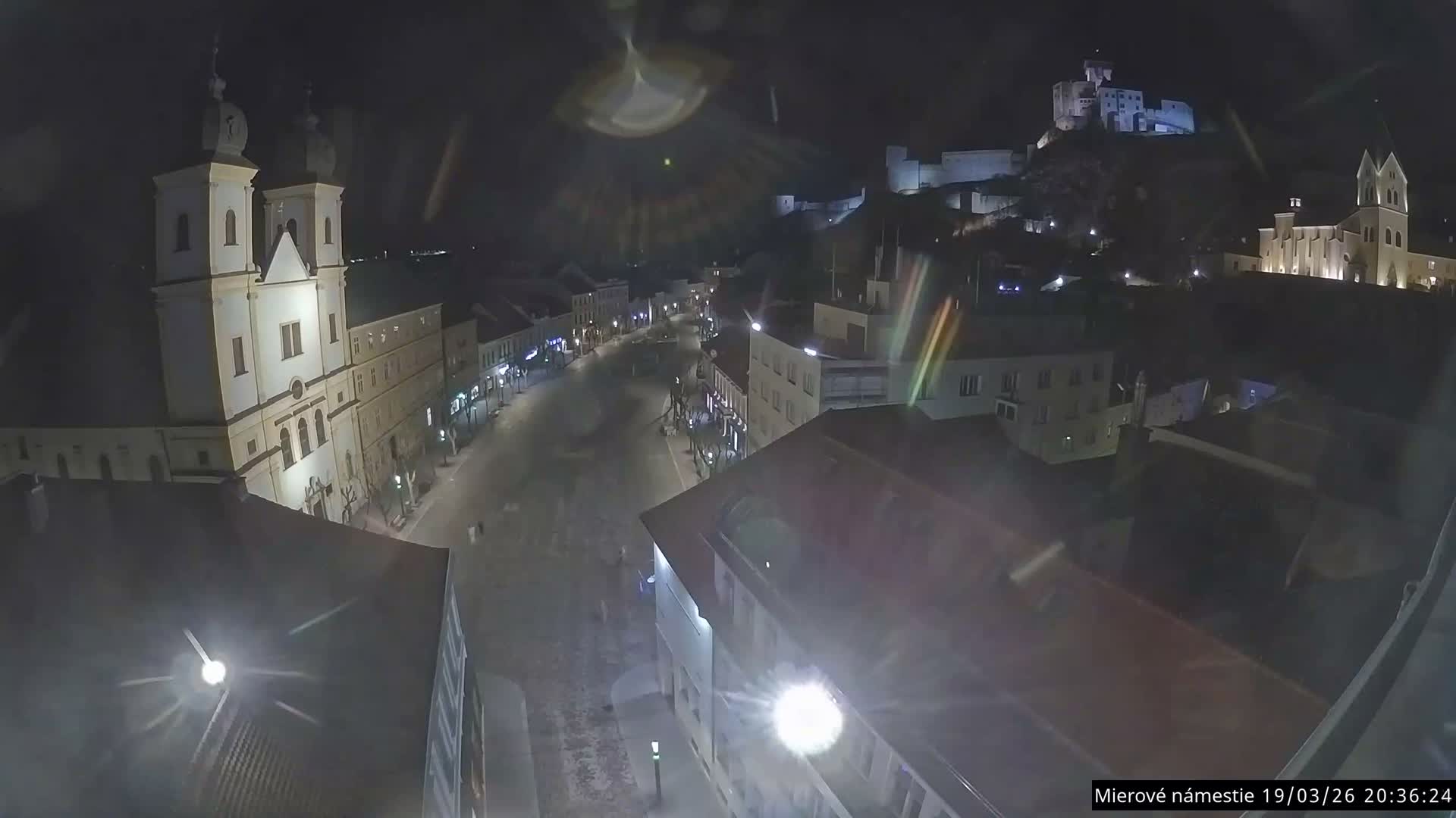 Trenčín, Piaristický kostol sv. Františka Xaverského Church & Trenciansky Hrad (Ttencin Castle) at Mierové námestie Square East View Live Cam - Trencin, Okres Trencin, Slovakia 