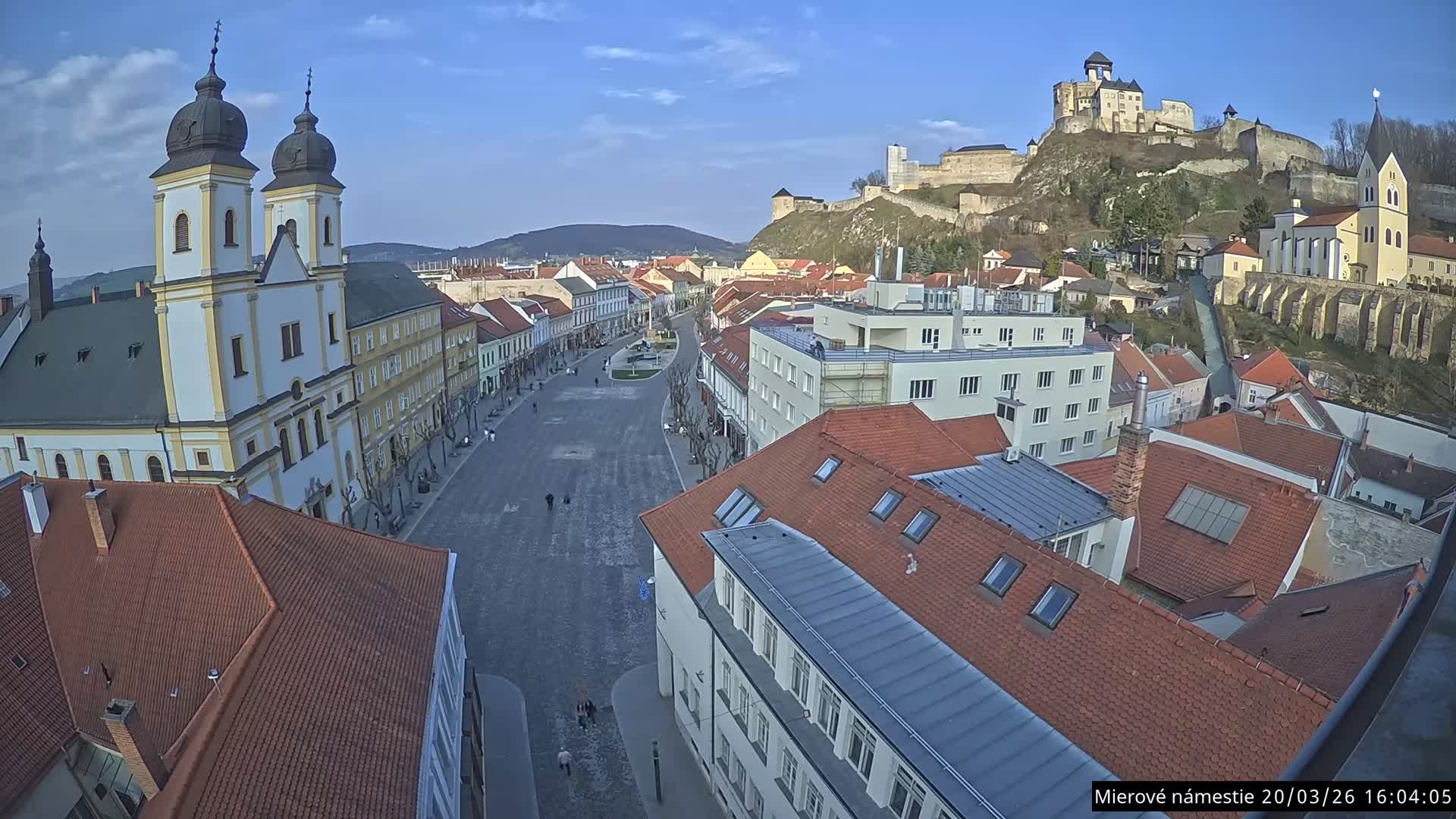 Trenčín, Piaristický kostol sv. Františka Xaverského Church & Trenciansky Hrad (Ttencin Castle) at Mierové námestie Square East View Live Cam - Trencin, Okres Trencin, Slovakia 