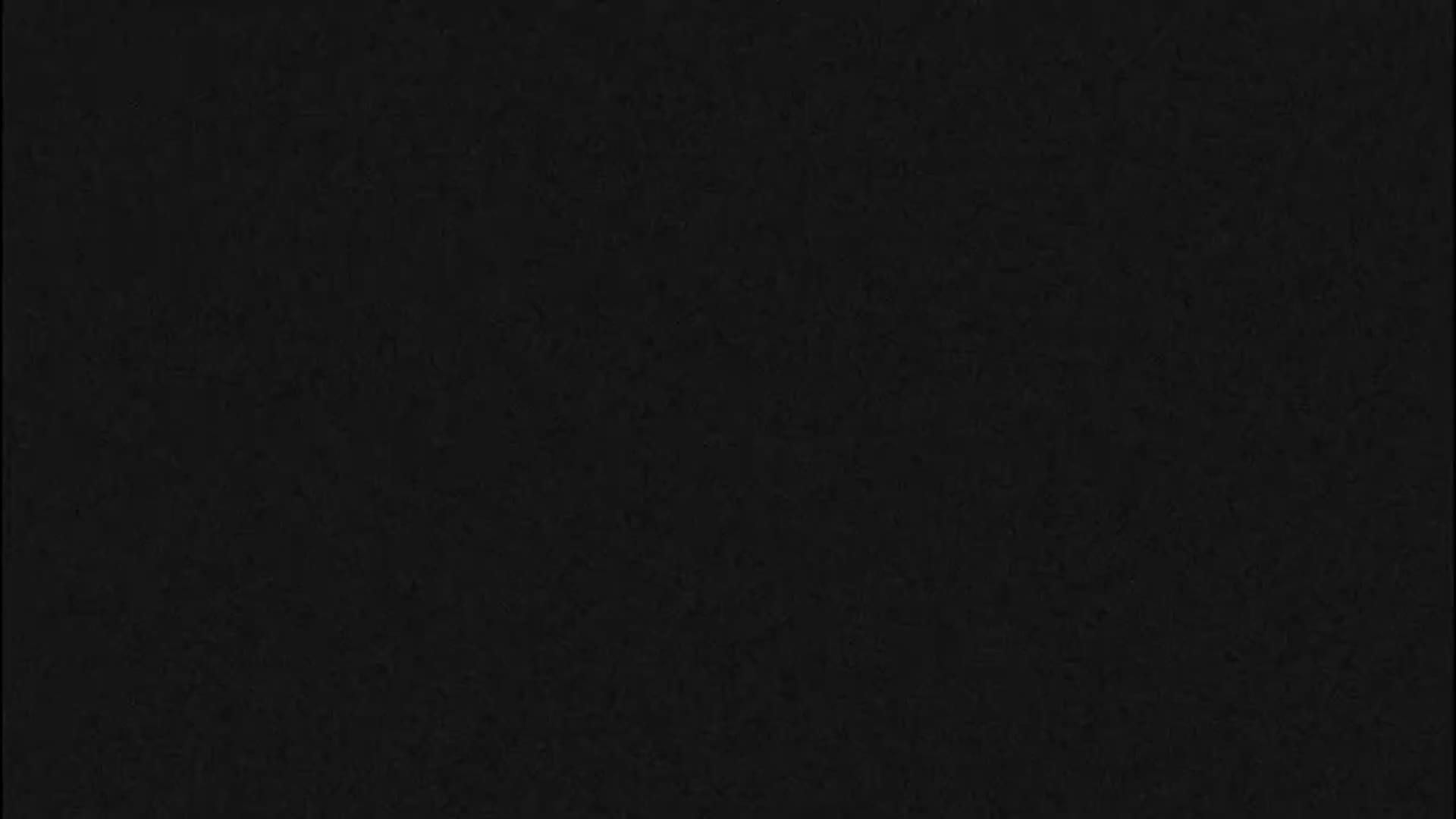 The image displays a solid black surface with a subtle, uniform grainy texture throughout.