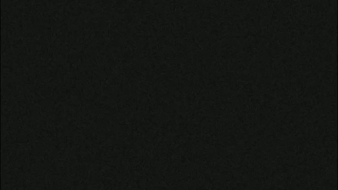 The image shows a dark gray or black textured surface.