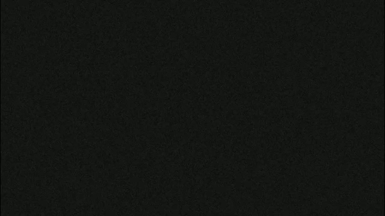 The image is a solid dark gray or black textured surface.