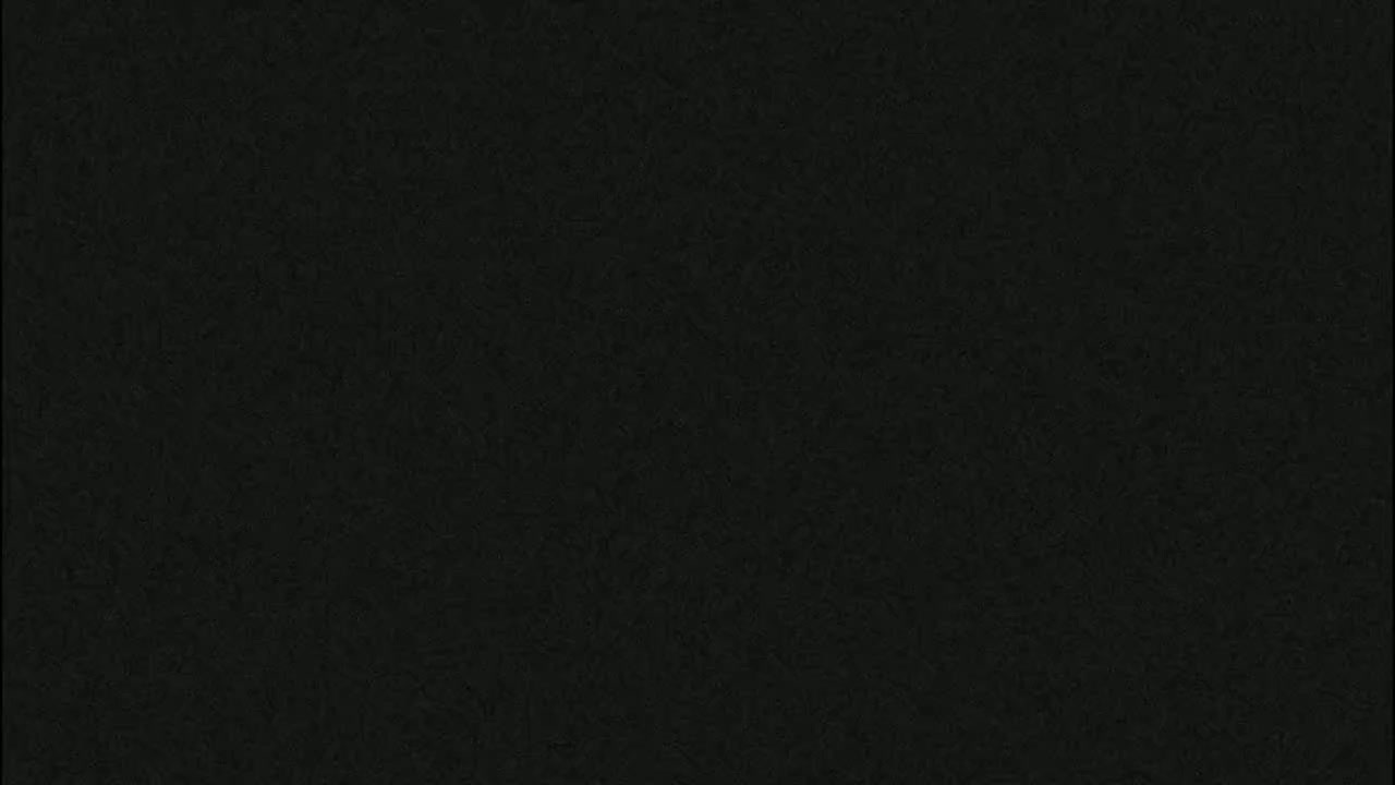 The image is a solid dark-grey or black field of subtly textured material.