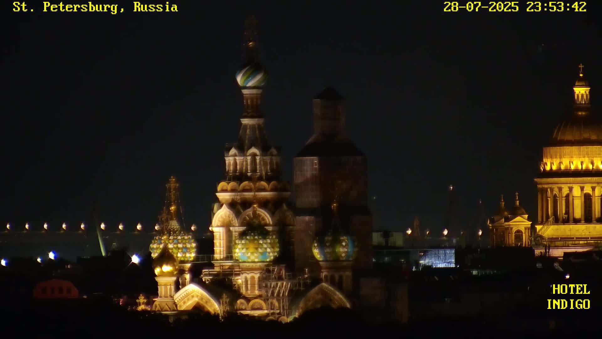 At night, illuminated ornate churches stand against a dark sky.