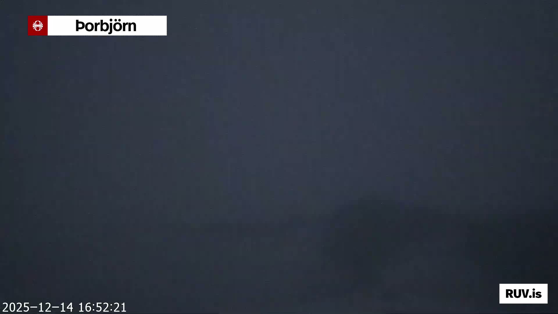 A cold, vast, and dark landscape, likely snow-covered, stretches under a speckled pre-dawn sky with a faint light emerging on the distant horizon.