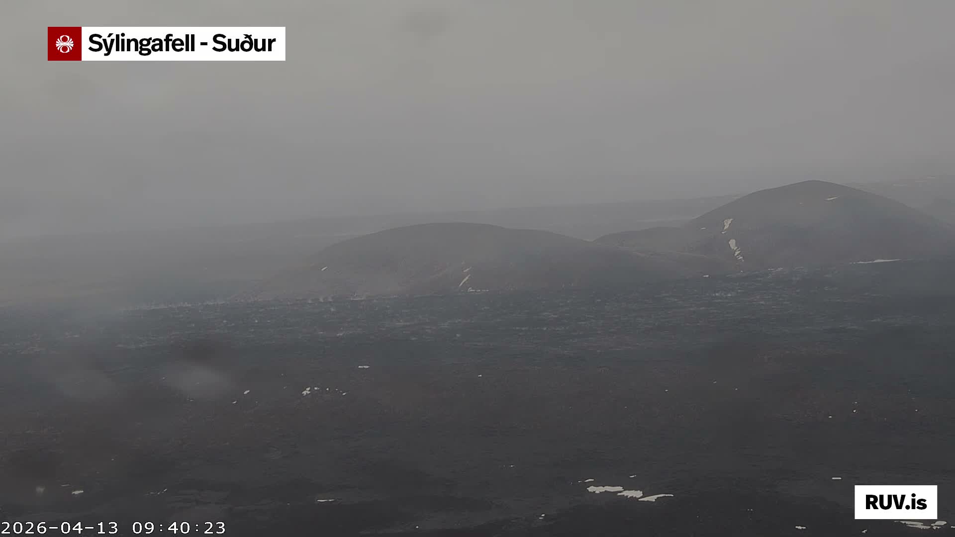 A dark, featureless outdoor scene is depicted in uniform shades of dark gray, suggesting an extremely low visibility night due to dense fog or heavy overcast conditions.