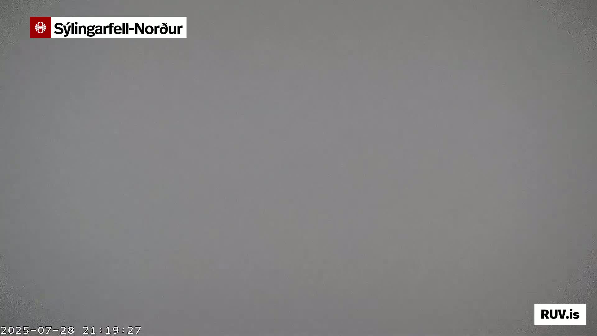 A uniformly gray, overcast sky is visible.