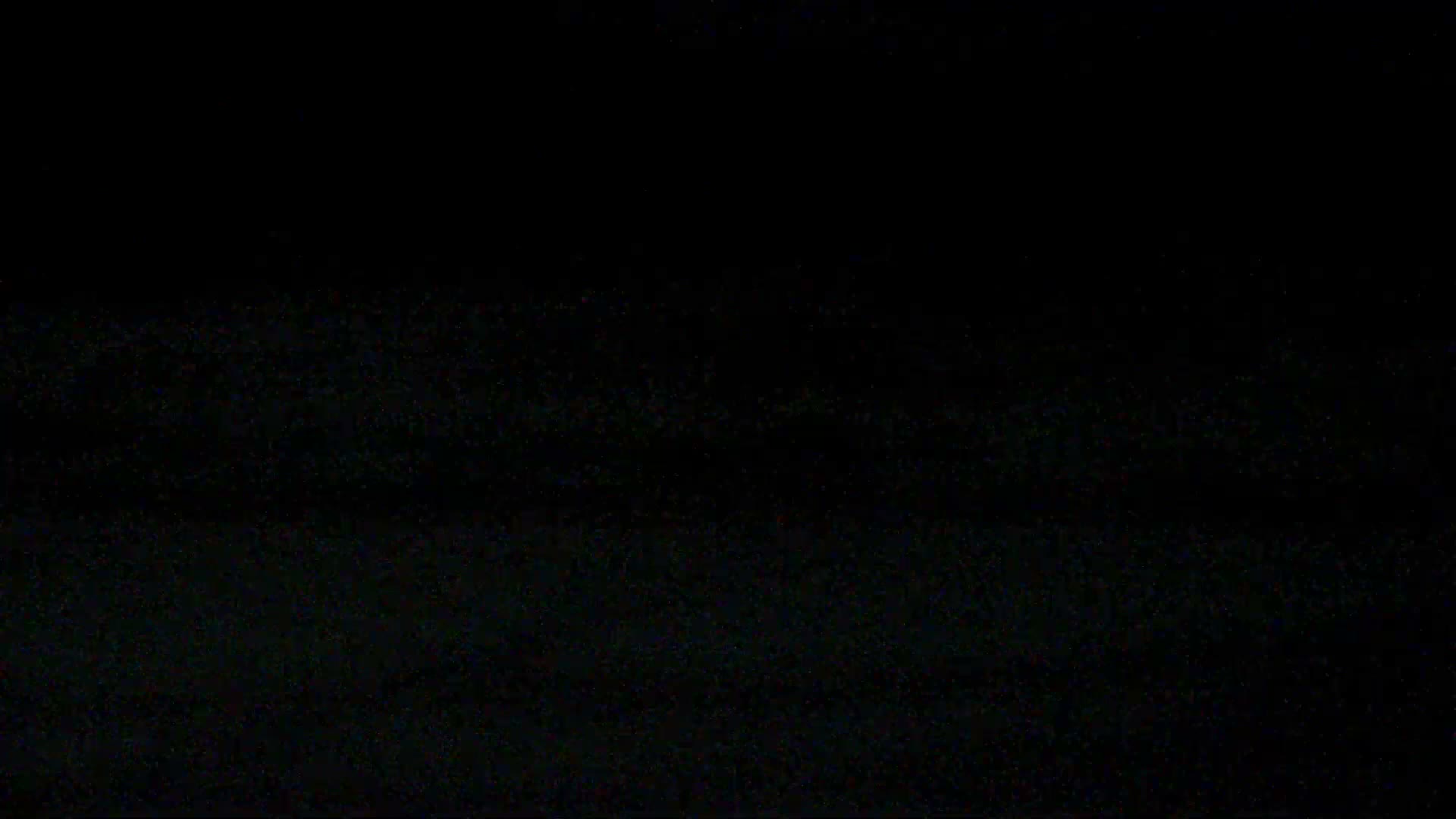 The image displays a very dark, nearly black field filled with subtle, scattered digital noise or static, primarily in very dark shades of green and red.