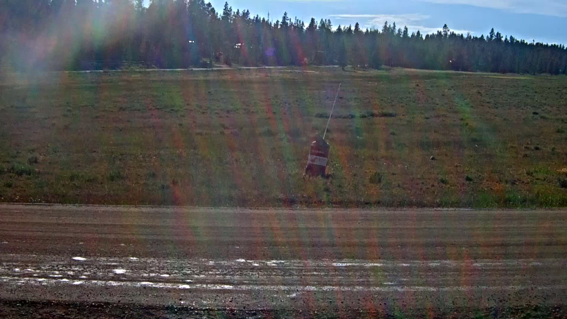 Several small, distant lights are visible in the dark, possibly at night.