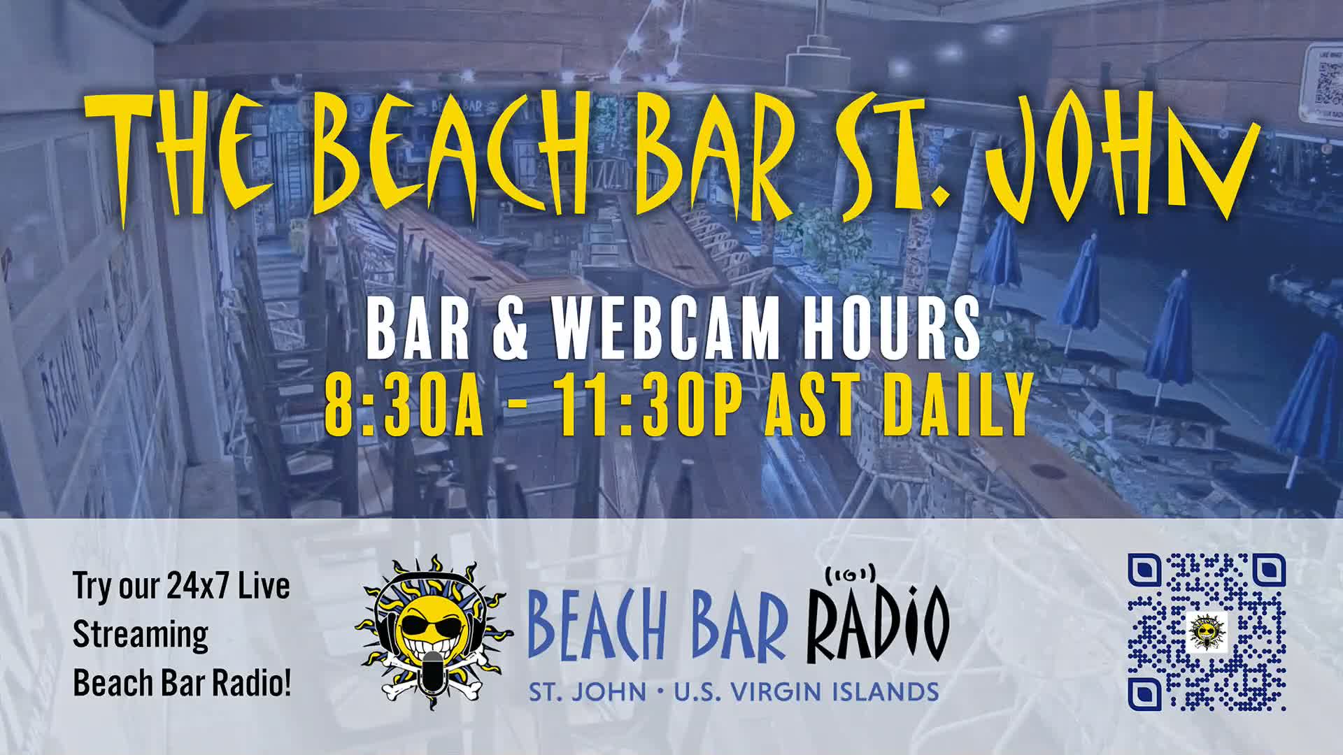 An illuminated outdoor bar patio, featuring wooden tables, chairs, blue umbrellas, and palm trees, is captured under clear evening or night conditions.