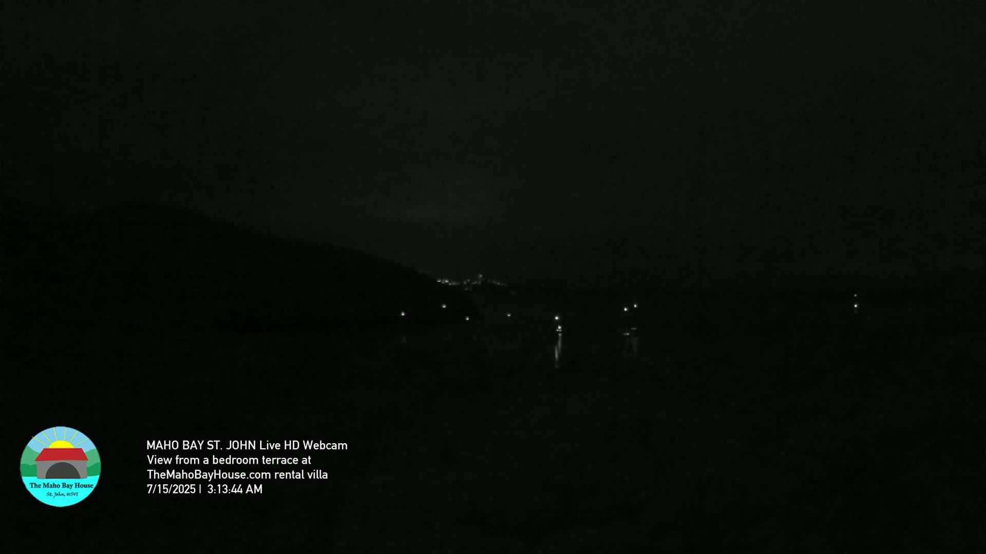 A nighttime view shows a dark landscape with a few distant lights.