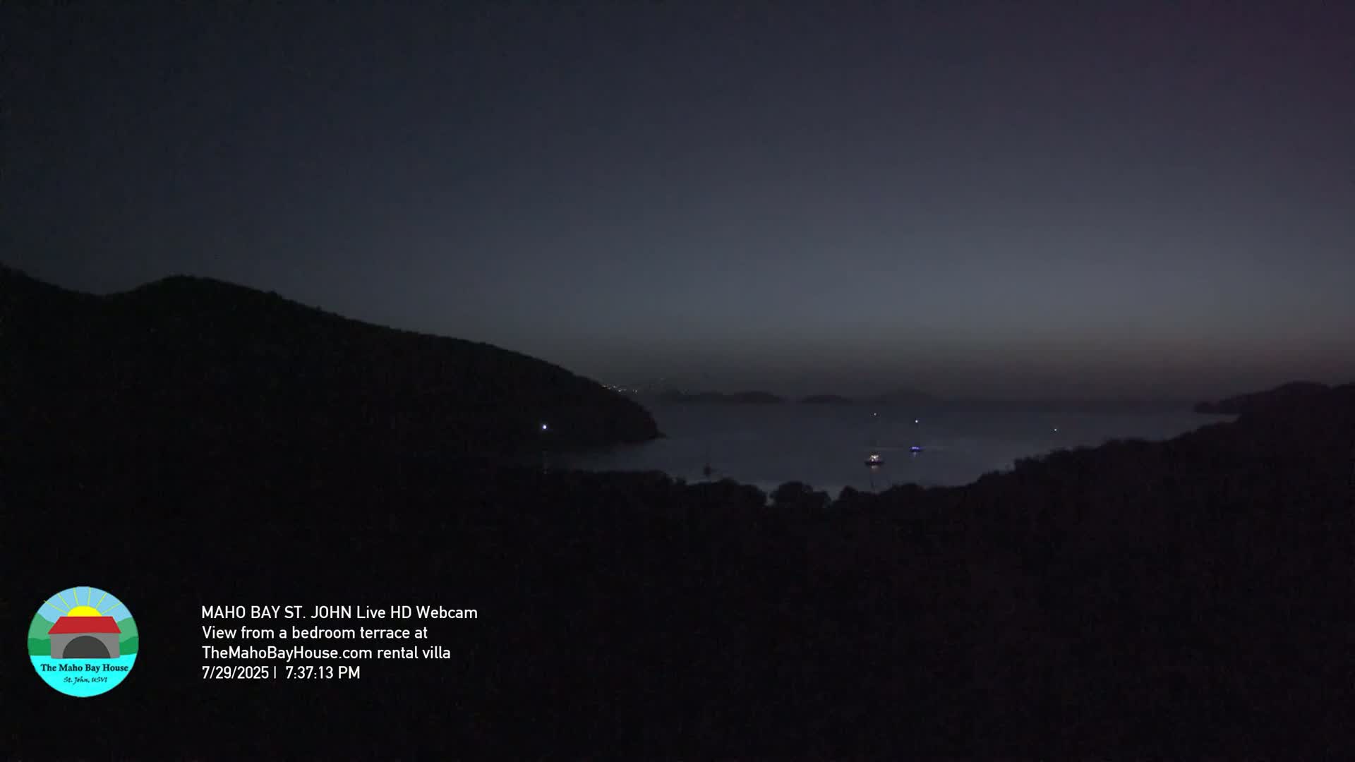 A nighttime view shows a dark landscape with a few distant lights.