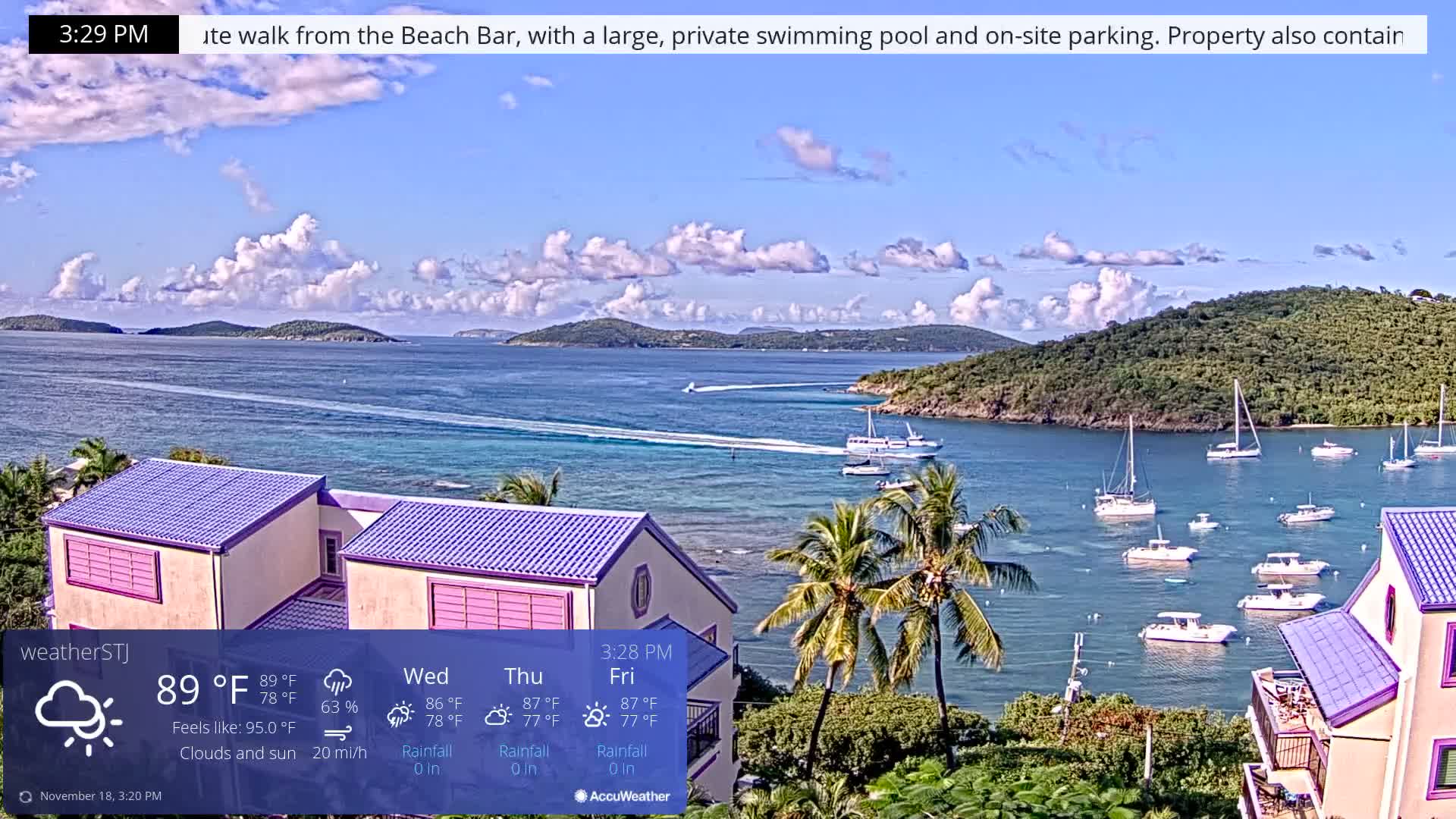 The image depicts a mostly clear, dark night in a tropical or coastal setting, featuring illuminated buildings, palm trees, and distant lights.