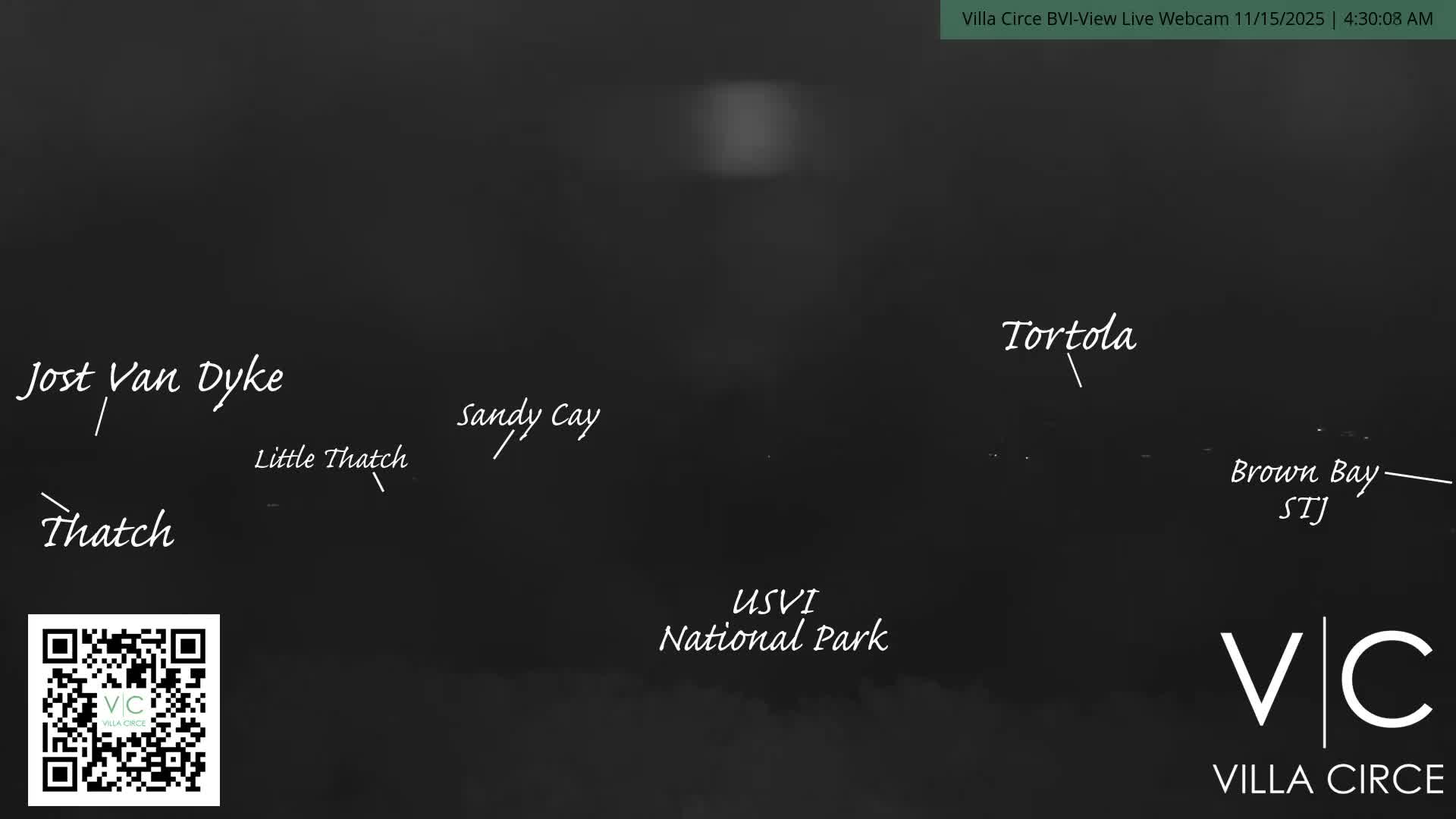 A very dark, pre-dawn outdoor scene features a faint horizon line separating dark water from a dark sky with a subtle glow, under clear weather conditions.