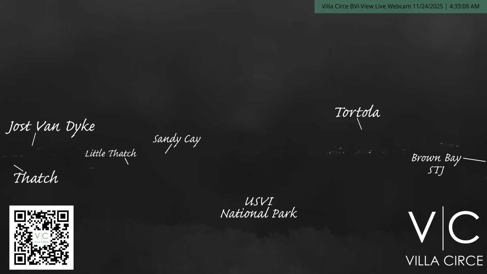 This is a dark, early morning webcam view of the ocean under a clear sky, with distant island lights visible on the horizon.