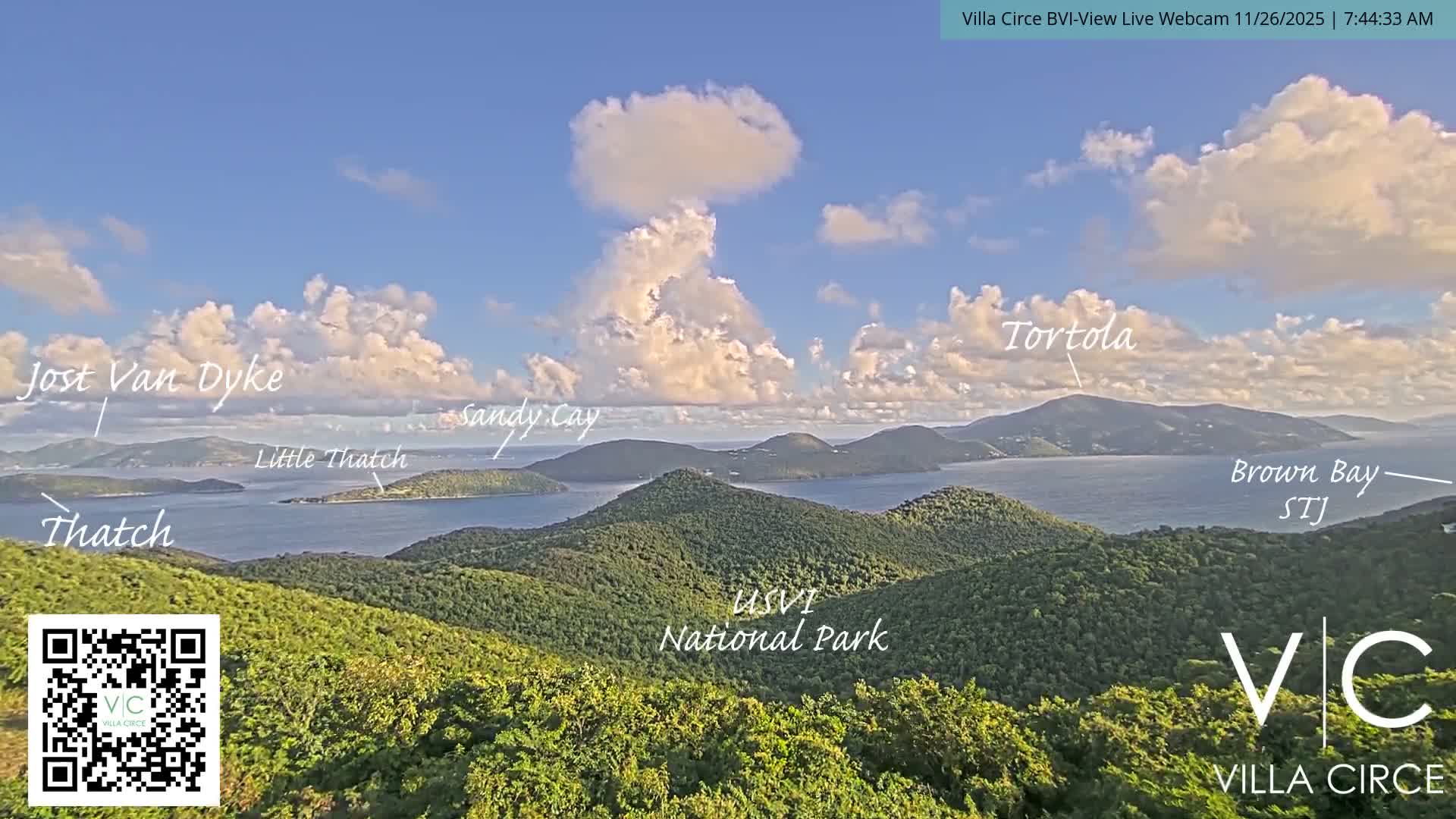 This is a dark, early morning webcam view of the ocean under a clear sky, with distant island lights visible on the horizon.