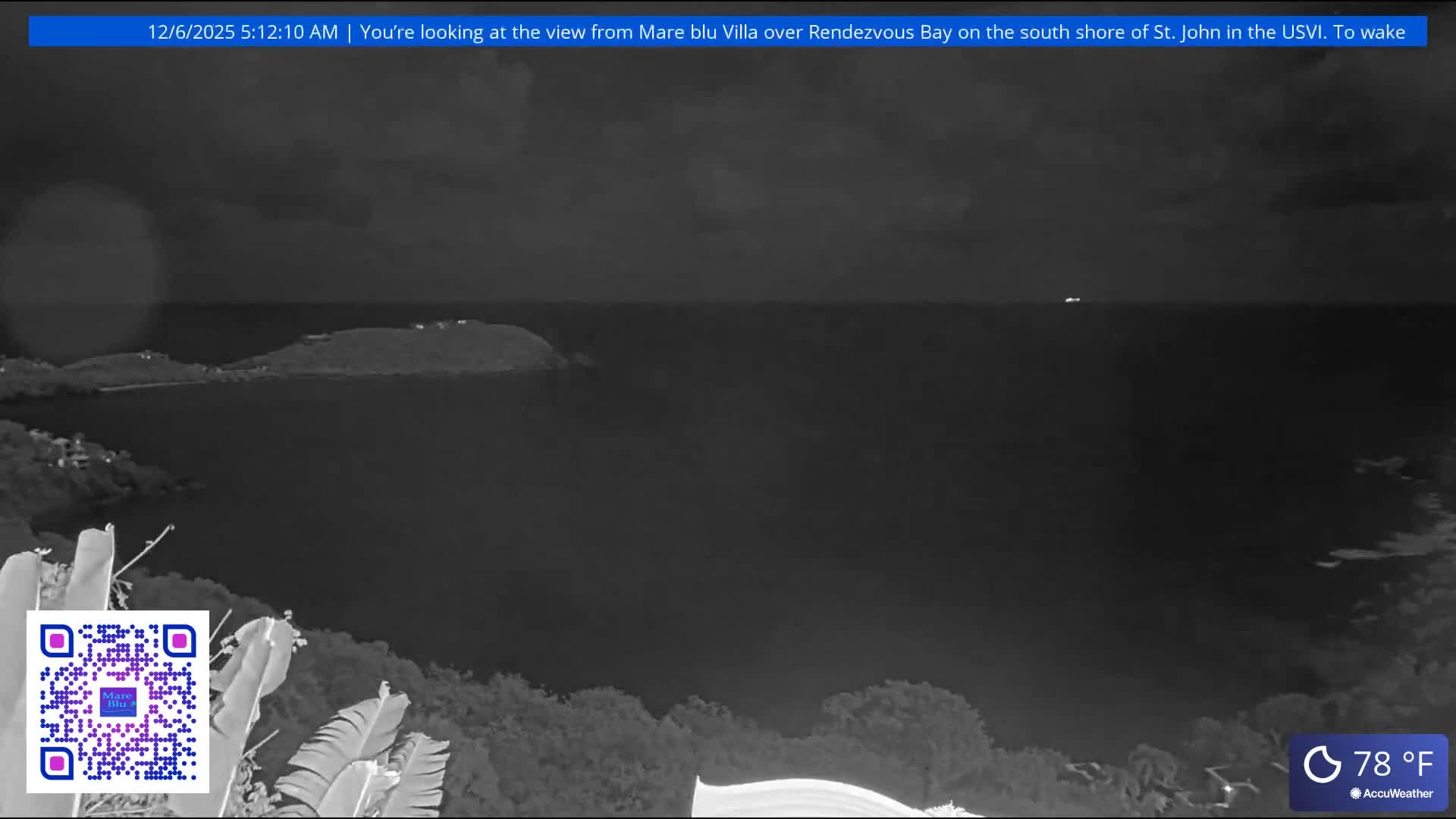 A cloudy night scene overlooks a bay with several distant landmasses and faint lights on the water, showing tropical foliage in the foreground, with a temperature of 78°F.