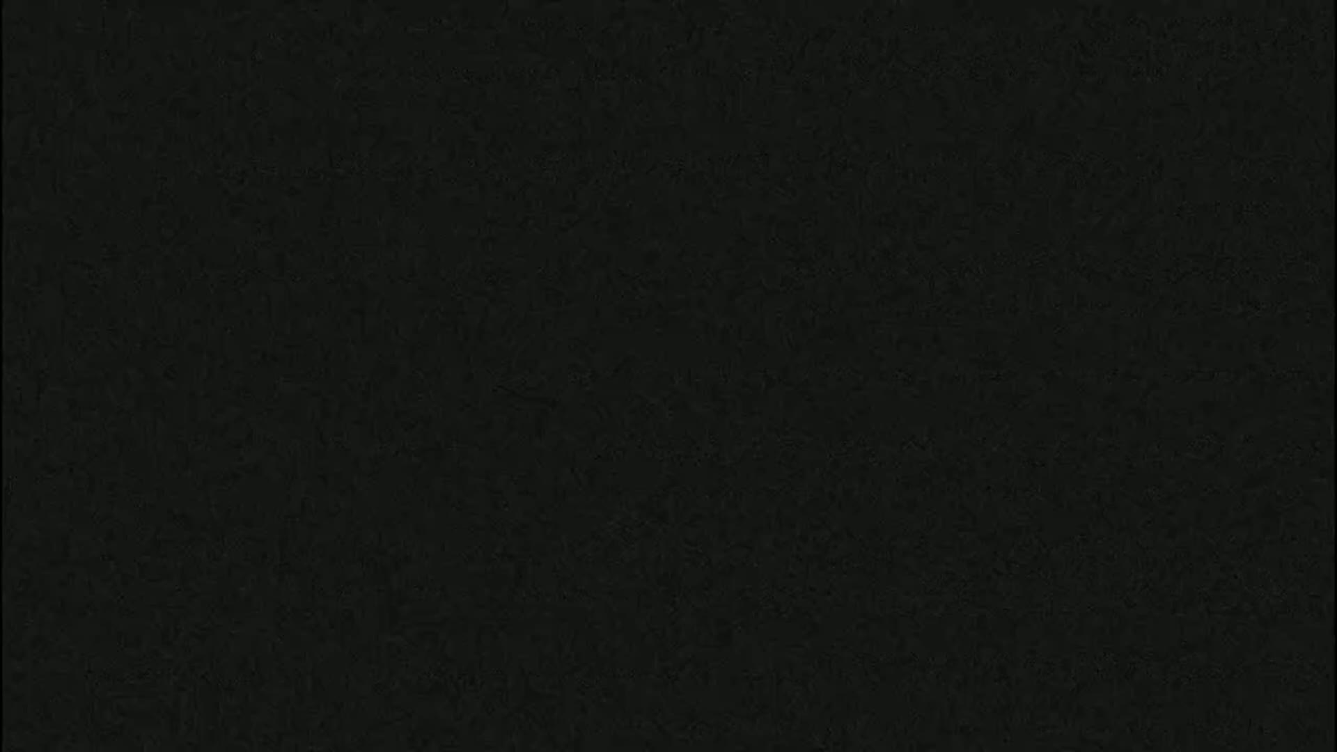 The image shows a dark gray or black textured surface.