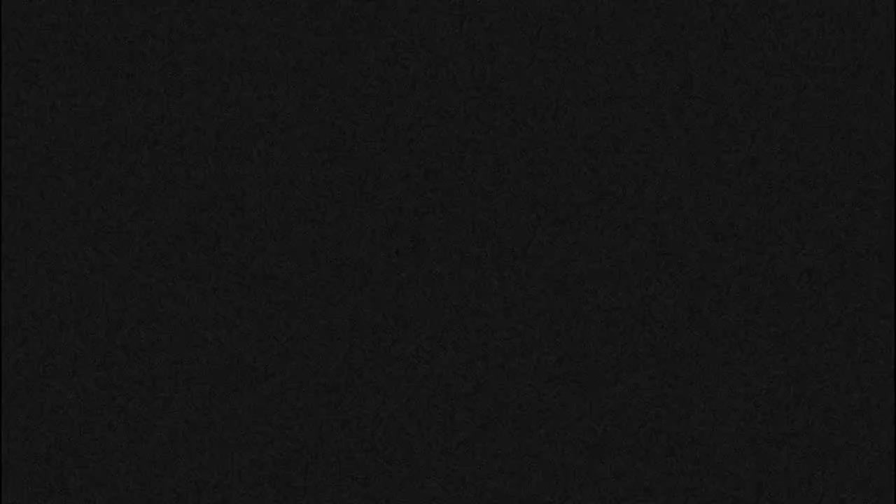 The image depicts a uniformly dark, nearly black surface with a subtle, fine-grained texture.