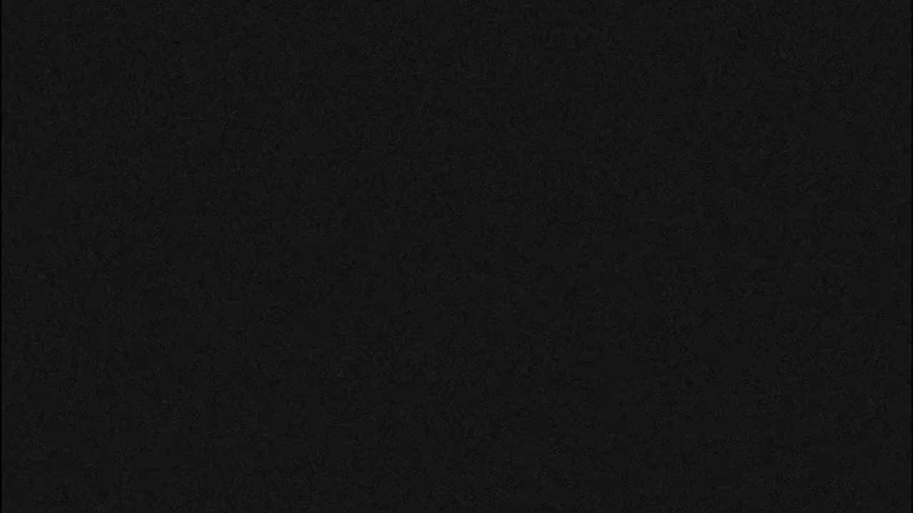 The image displays a uniform black field with a very subtle, fine-grained texture.