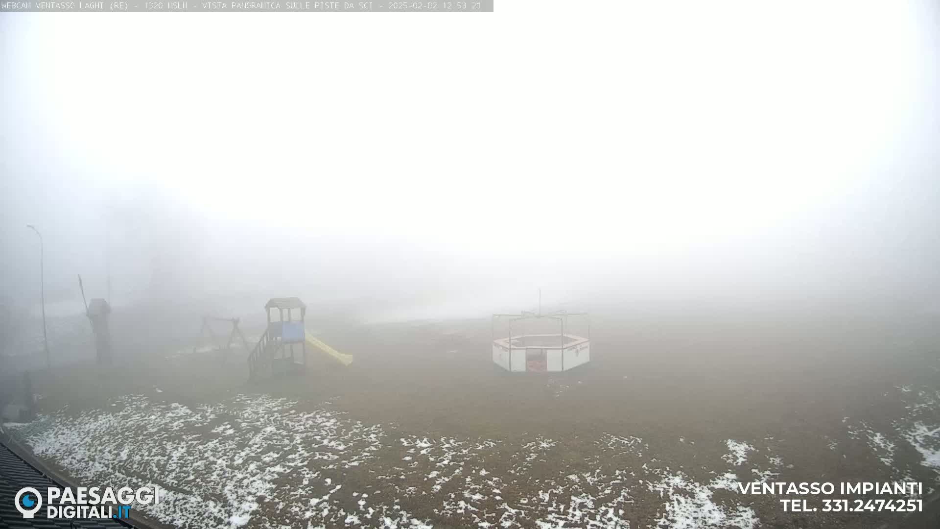 A foggy playground with a slide and a carousel is partially visible in a snow-dusted area.