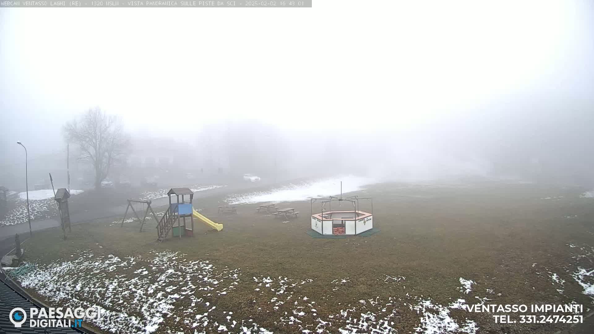 A foggy playground with a slide and play structures is visible, with patches of snow on the ground.