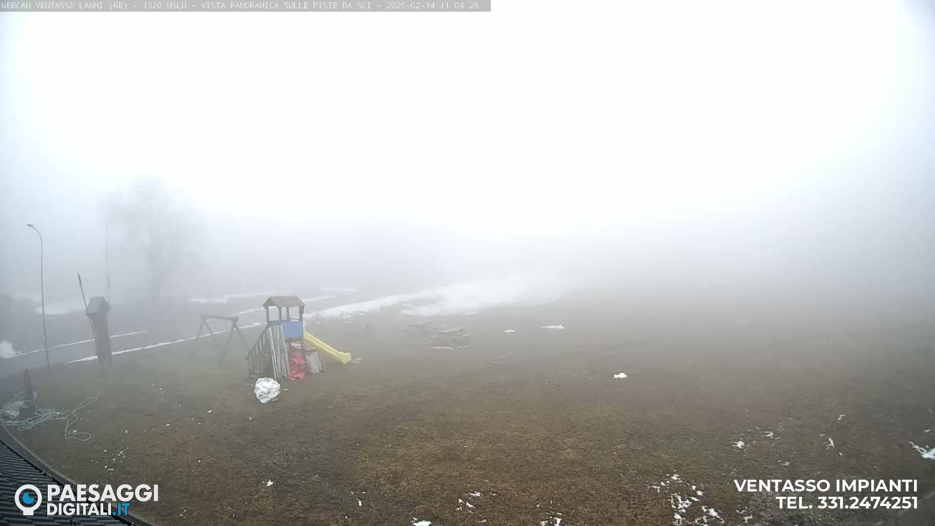 A playground is visible in a foggy, outdoor setting with patches of snow on the ground.
