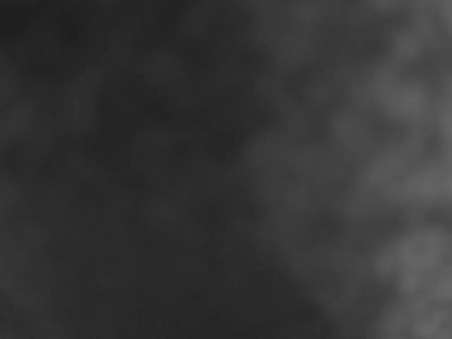 The image displays an abstract, blurry, mottled texture in shades of dark grey and black.