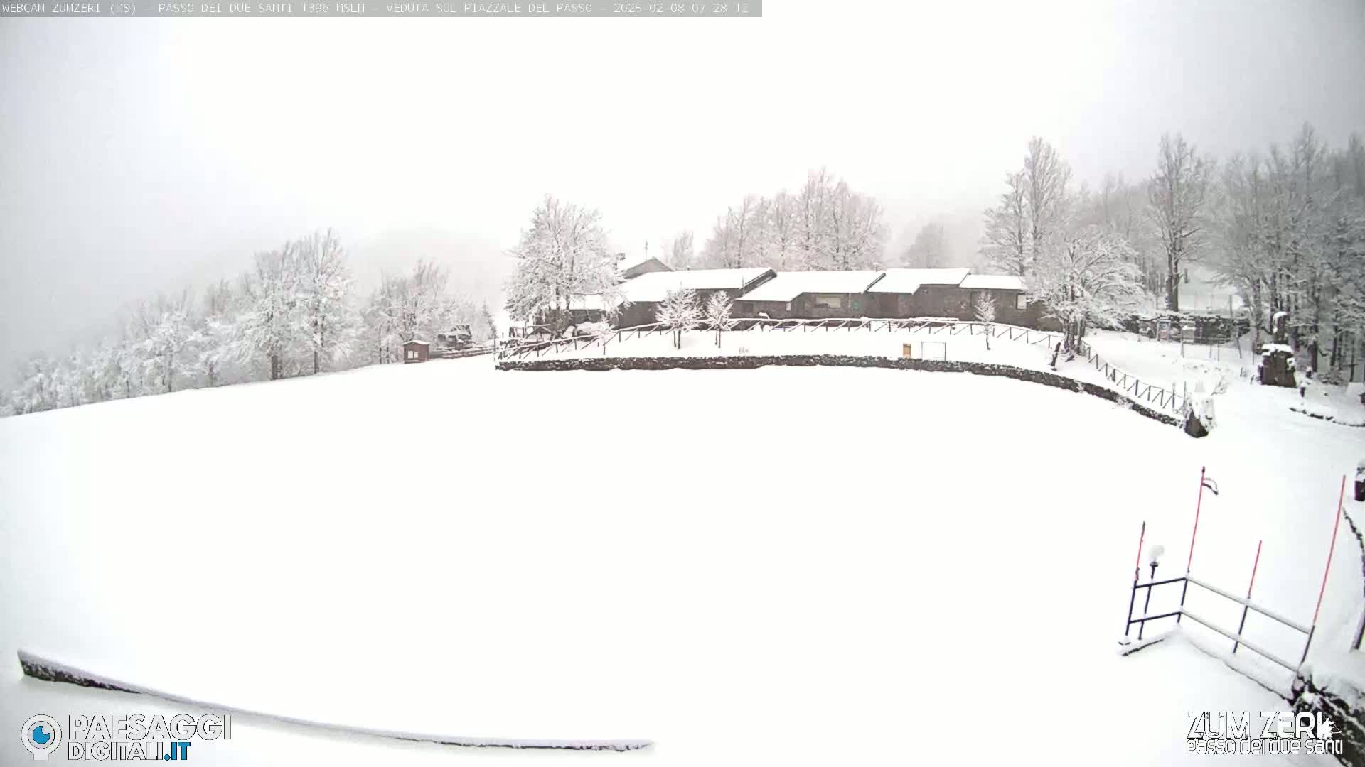 Snow-covered buildings and trees are visible in a snowy landscape.