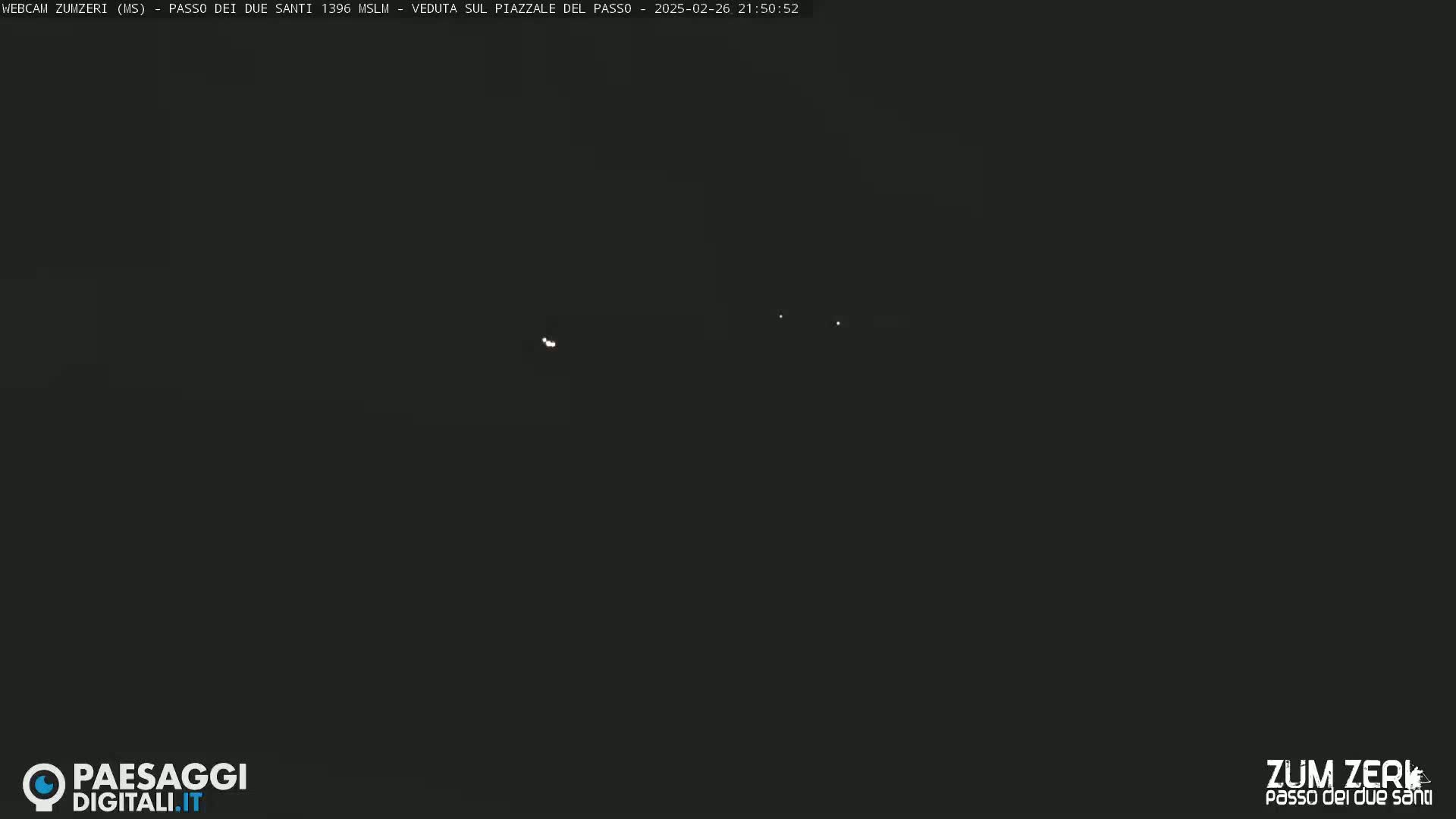 A nighttime outdoor scene shows a dark sky with several faint lights.