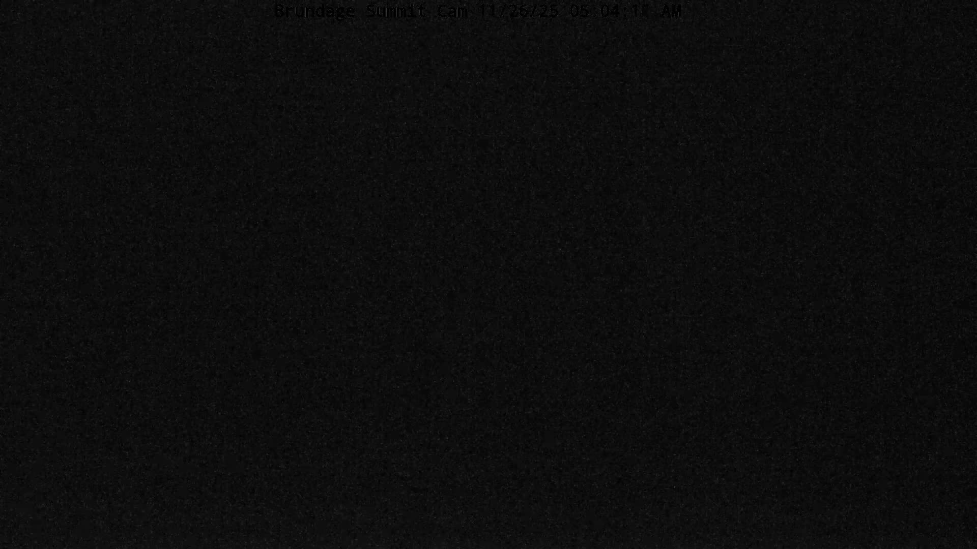 It is a clear, dark night with distant lights forming a horizon line and a closer pair of bright lights visible against the black expanse.