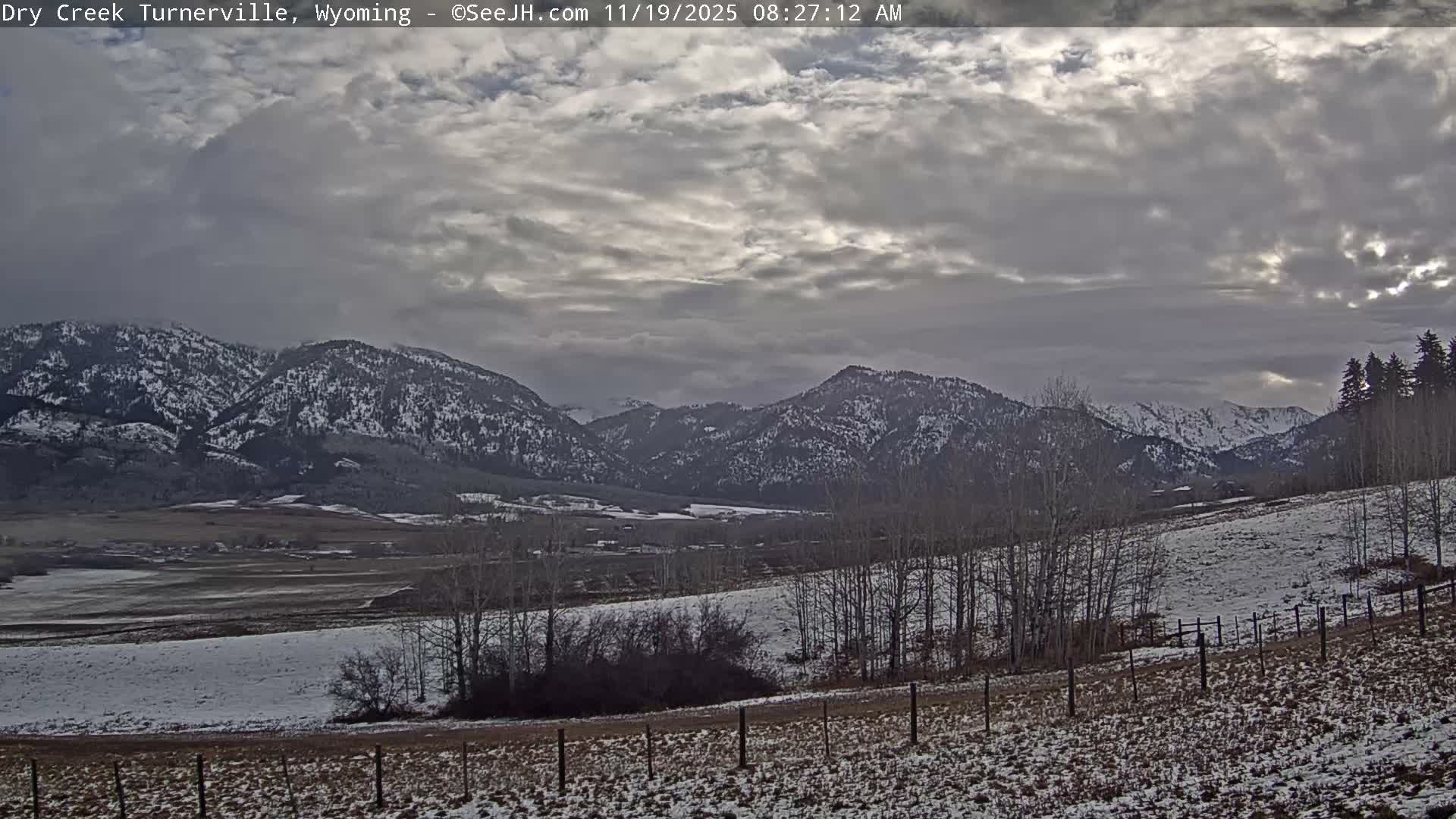Several small, bright distant lights are visible against a dark landscape on a clear night.