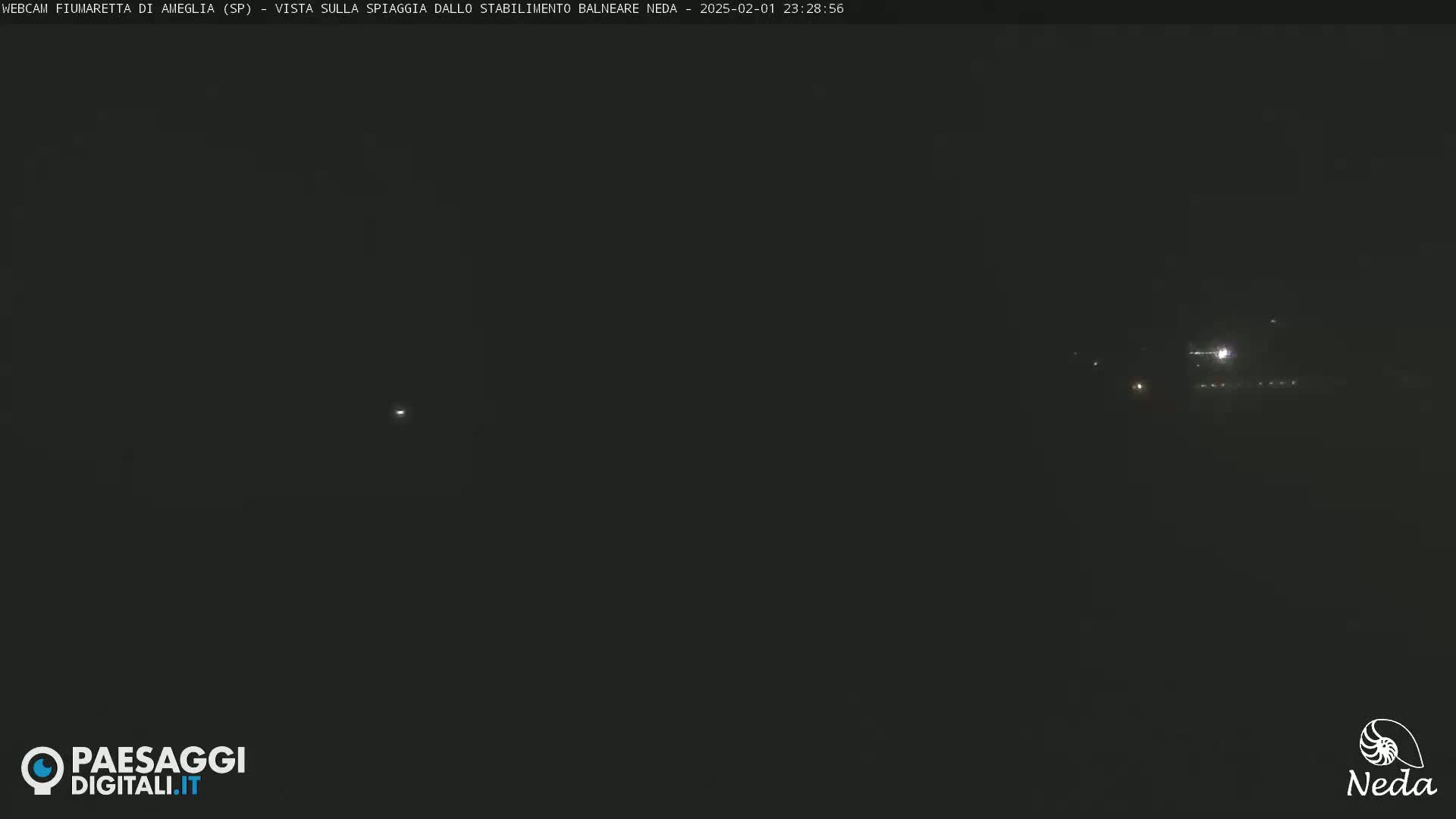A nighttime long shot shows a dark beach with a few distant lights.
