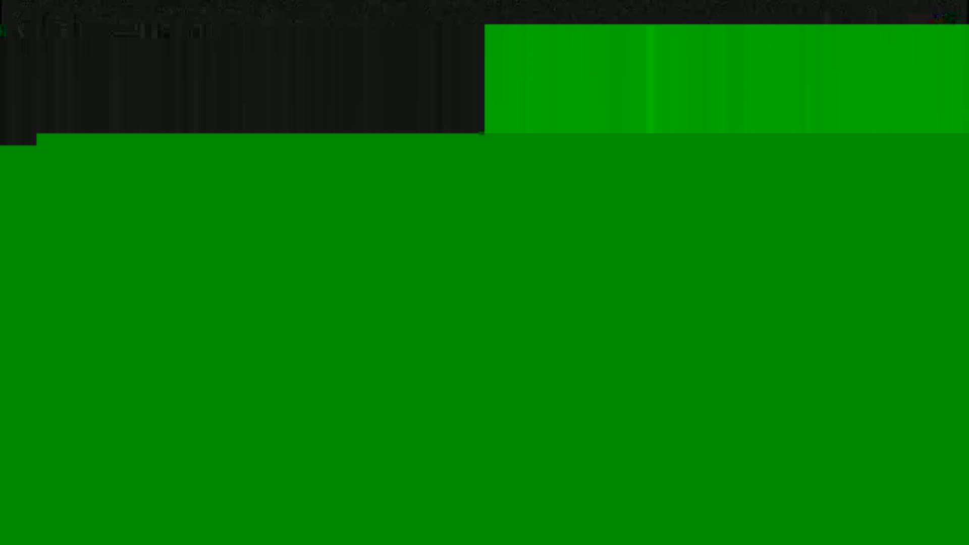 The image shows a mostly solid green field with a small section of dark gray at the top.